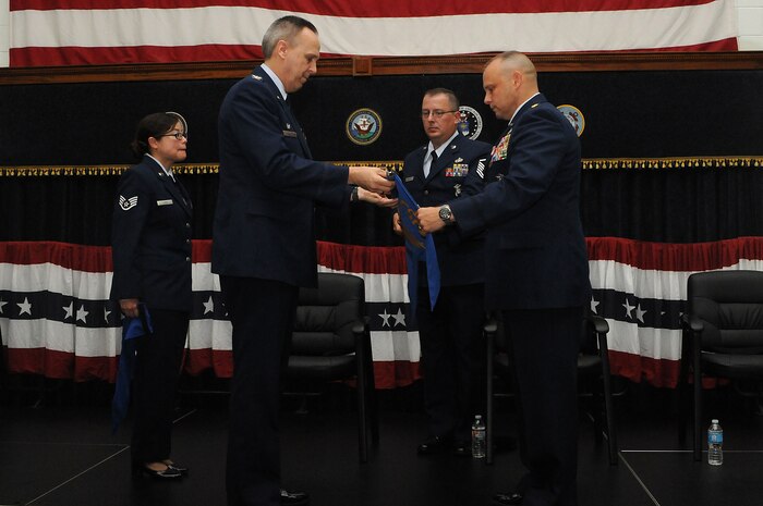 Colonel Mike Kelly and Maj. Kenneth Decedue Jr., secure the Detachment 3, Air Force Security Forces Center command guidon during an inactivation ceremony at the Naval Consolidated Brig Charleston on Joint Base Charleston – Weapons Station, May 3. Detachment 3 will scale down in size from 24 to seven assigned Airmen who will continue the Air Force corrections mission and integrate with NCBC. The Airmen will be officially assigned to Air Force Detachment 2 located at the Naval Brig Miramar, Calif. Kelly is the Headquarters AFSFC commander and Decedue is the Det 3 commander. (U.S. Navy photo/Petty Officer 1st Class Jennifer Hudson).