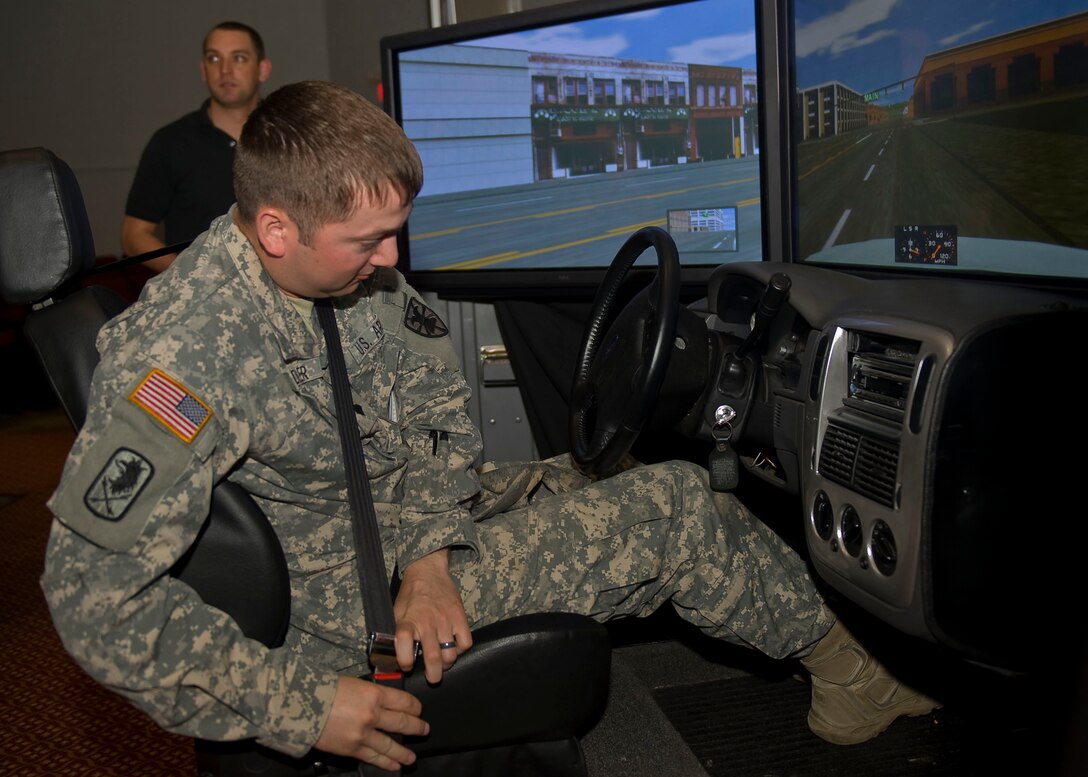U.S. Army Spc. Steven Saddler, 7th Sustainment Brigade, straps into the drunk driving simulator during the Save-a-Life Tour presentation at Fort Eustis' Jacobs Theater May 3, 2012. The Save-a-Life Tour simulator puts drivers behind the wheel  while simulating drunk driving conditions, mimicking the effects alcohol has on motorists. (U.S. Air Force photo by Senior Airman John D. Strong II/Released)