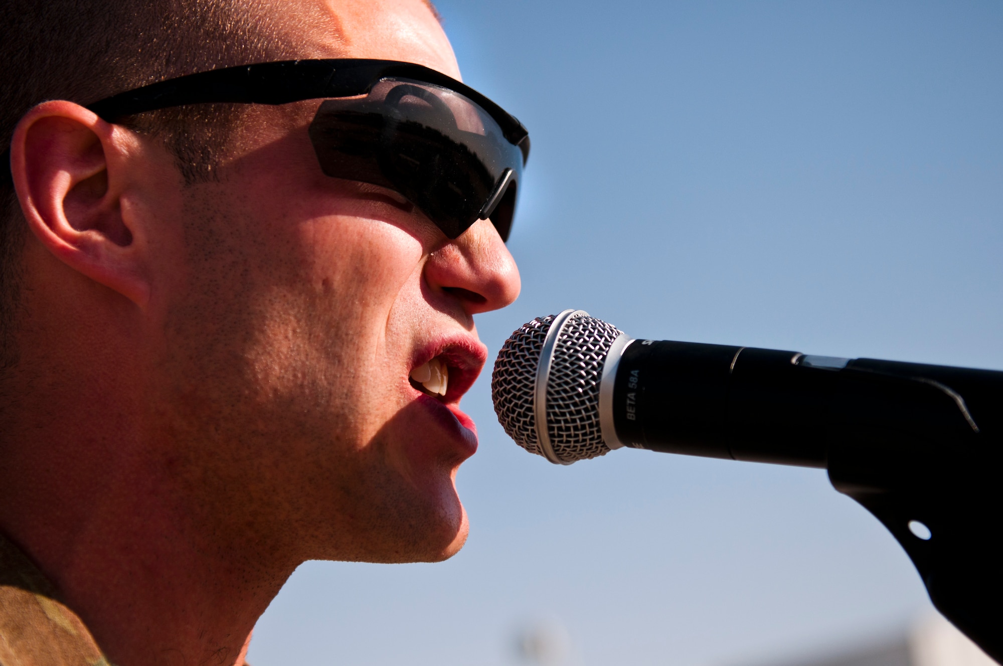 Airman 1st Class Lee Heerspink, a guitarist and vocalist with the U.S. Air Forces Central Command Nightwing, sings The Beatles number one hit song, Come Together, May 3, 2012 at Kandahar Airfield Afghanistan. The band played
for more than 1,000 U.S. and Coalition Forces members during this show. (U.S. Air Force photo by Staff Sgt. David Salanitri/Released)