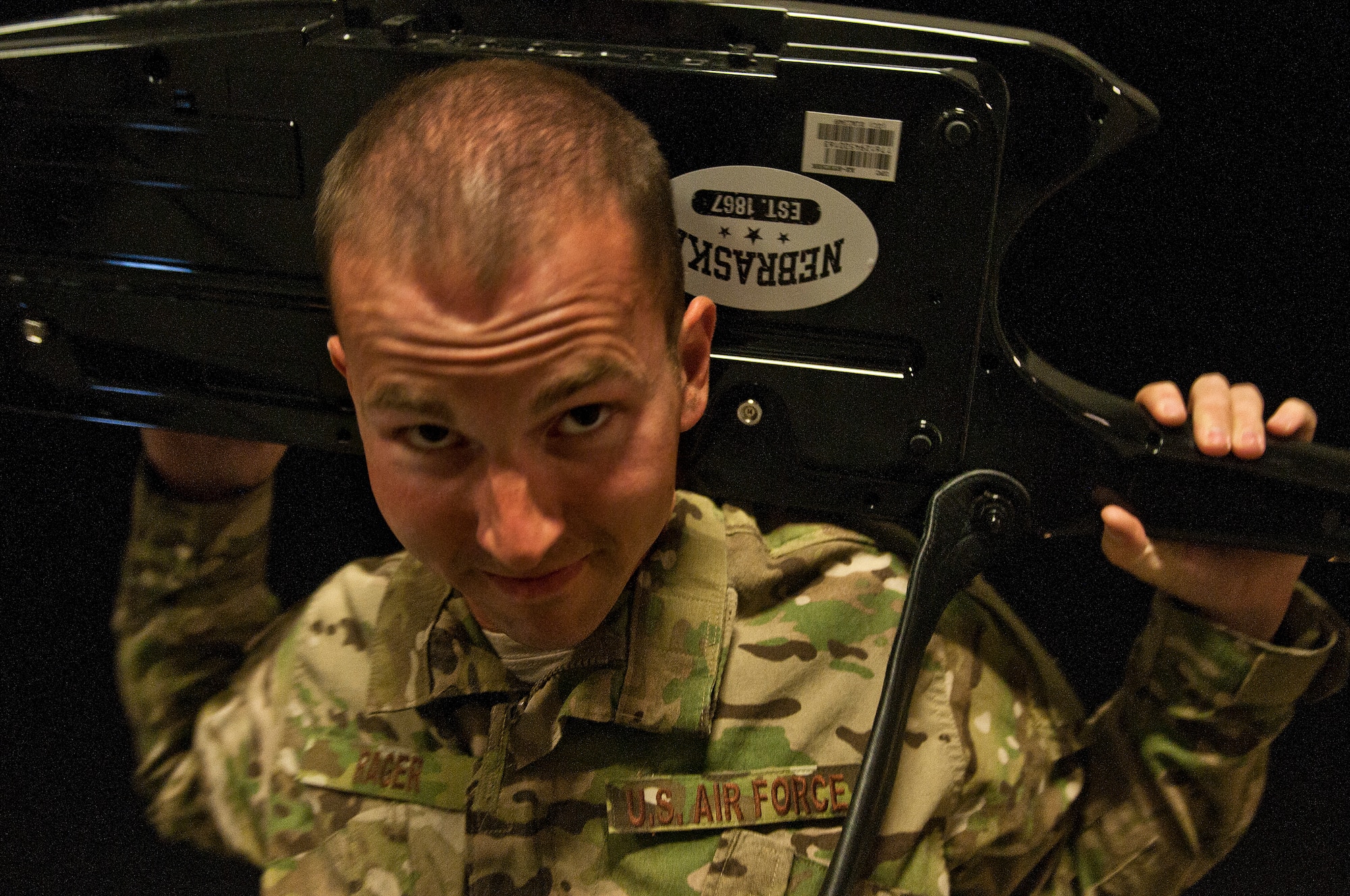 Senior Airman Ryan Rager, a member of the U.S. Air Forces Central Band Nightwing, plays his keytar behind his head during a concert May 2, 2012 at Kandahar Airfield, Afghanistan. During their shows, Nightwing tries hard to provide entertainment for the crowd. (U.S. Air Force photo by Staff Sgt. David Salanitri/Released)