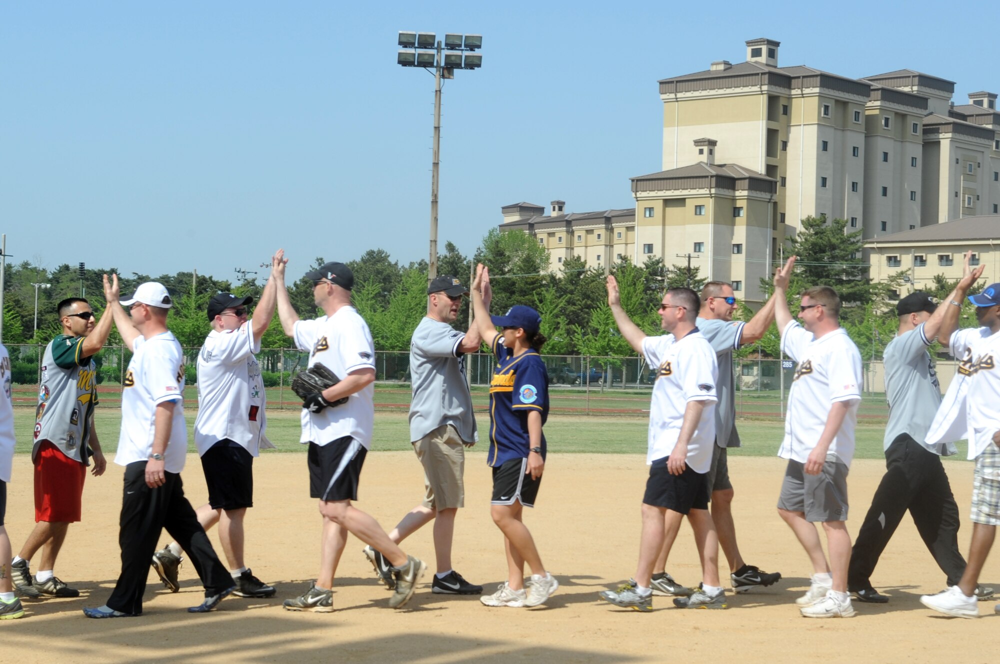 Chief master sergeants and colonels from the 8th Fighter Wing congratulate each other for a good game after the Chiefs vs. Eagles softball game May 4, 2012, on Kunsan Air Base, Republic of Korea. The game was one of several sporting events the Wolf Pack used to celebrate the 8th FW’s “Excellent” Consolidated Unit Inspection rating. (U.S. Air Force photo/Senior Airman Brigitte N. Brantley)