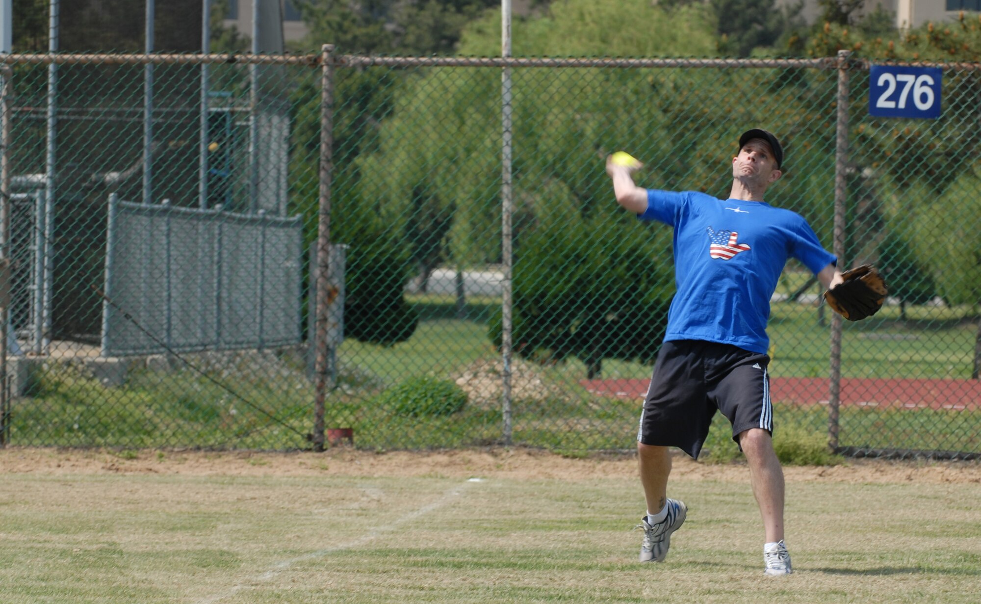 Lt. Col. Steven Boatright, 35th Fighter Squadron commander, returns a hit that made it to the outfield during the Chiefs vs. Eagles softball game May 4, 2012, on Kunsan Air Base, Republic of Korea. A majority of the plays during game happened on the infield. (U.S. Air Force photo/Senior Airman Brigitte N. Brantley)