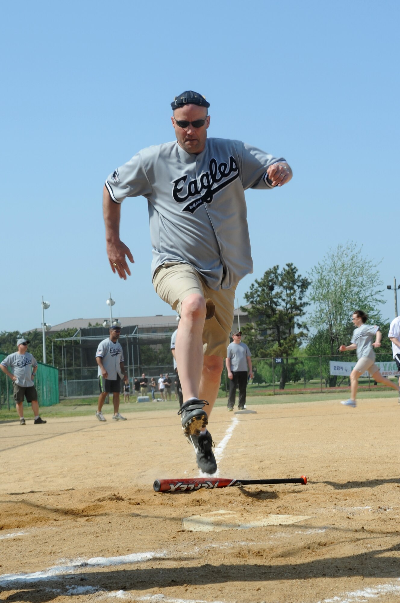 Col. Dane West, 8th Maintenance Group commander, leaps for the home plate May 4, 2012, during the Chiefs vs. Eagles softball game at Kunsan Air Base, Republic of Korea. The colonels got a few good runs in, but the chiefs grabbed and held on to their lead, winning 27-7. (U.S. Air Force photo/Senior Airman Brigitte N. Brantley)