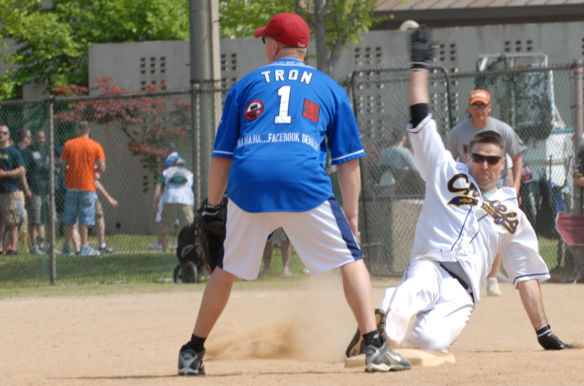 Chief Master Sgt. Scott Delveau, right, 8th Fighter Wing command chief, slides into second base while Maj. Brian Snyder, 8th Communications Squadron commander, anticipates the ball May 4, 2012, at Kunsan Air Base, Republic of Korea. The game was part of a full day of sporting events celebrating the end of the 8th Fighter Wing Consolidated Unit Inspection. (U.S. Air Force photo/Senior Airman Brigitte N. Brantley)