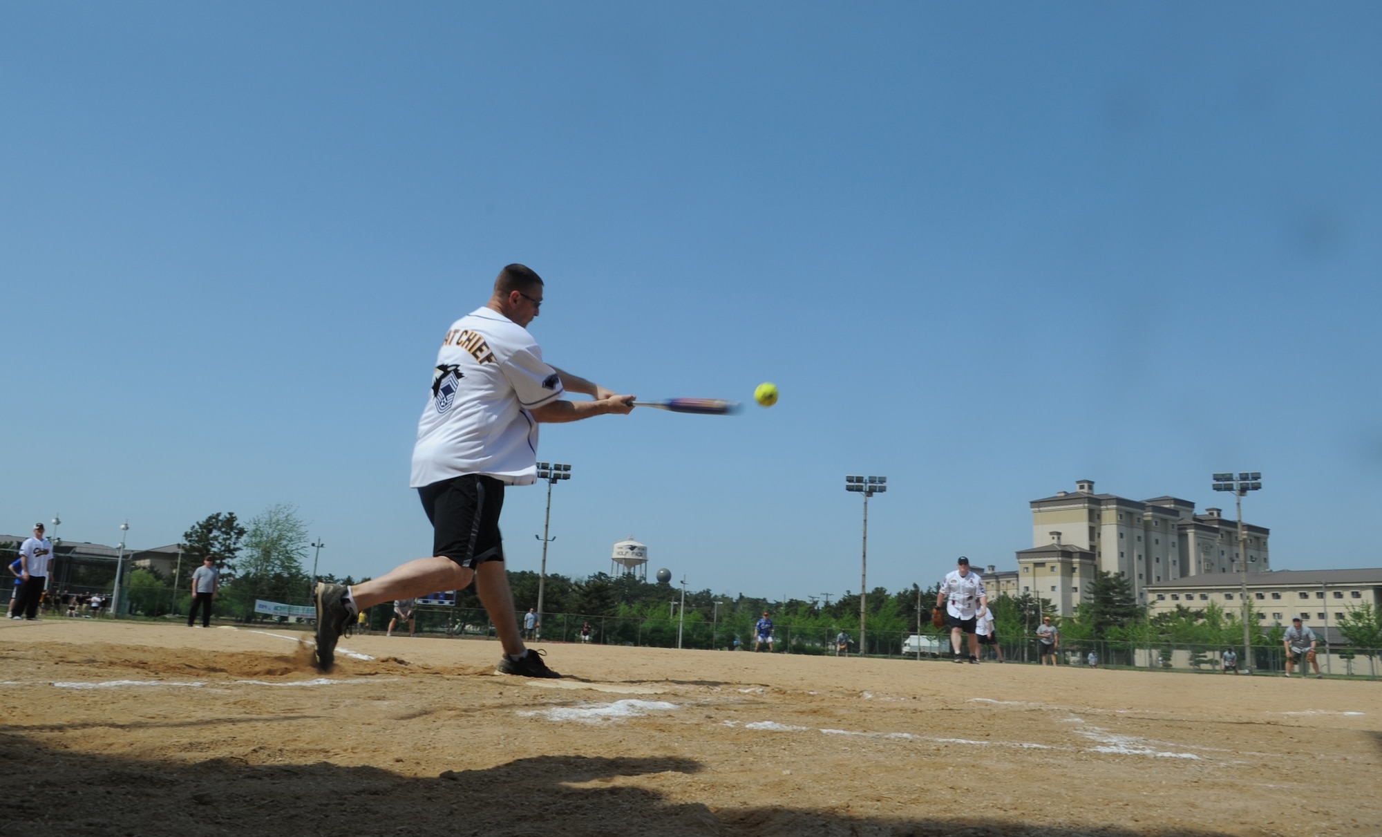Chief Master Sgt. David Johnson, 80th Fighter Squadron, hits the ball toward the outfield during the Chiefs vs. Eagles softball game May 4, 2012, on Kunsan Air Base, Republic of Korea. The chief master sergeants beat out the colonels 27-7. (U.S. Air Force photo/Senior Airman Brigitte N. Brantley)