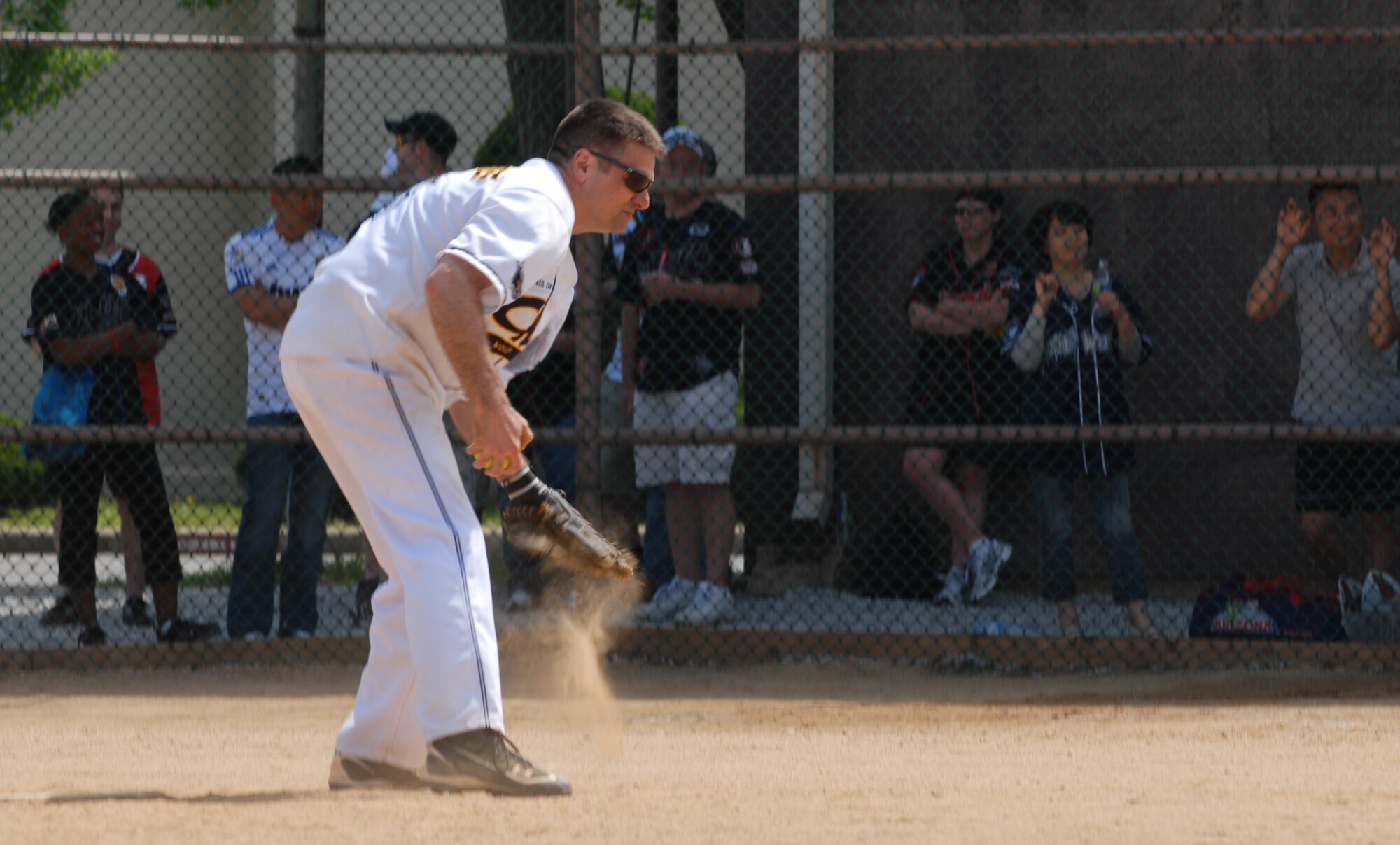 Chief Master Sgt. Scott Delveau, 8th Fighter Wing command chief, dusts his glove before pitching during the Chiefs vs. Eagles softball game May 4, 2012, on Kunsan Air Base, Republic of Korea. Delveau, in his last event as Wolf Chief, helped the team win 27-7. (U.S. Air Force photo/Senior Airman Brigitte N. Brantley)