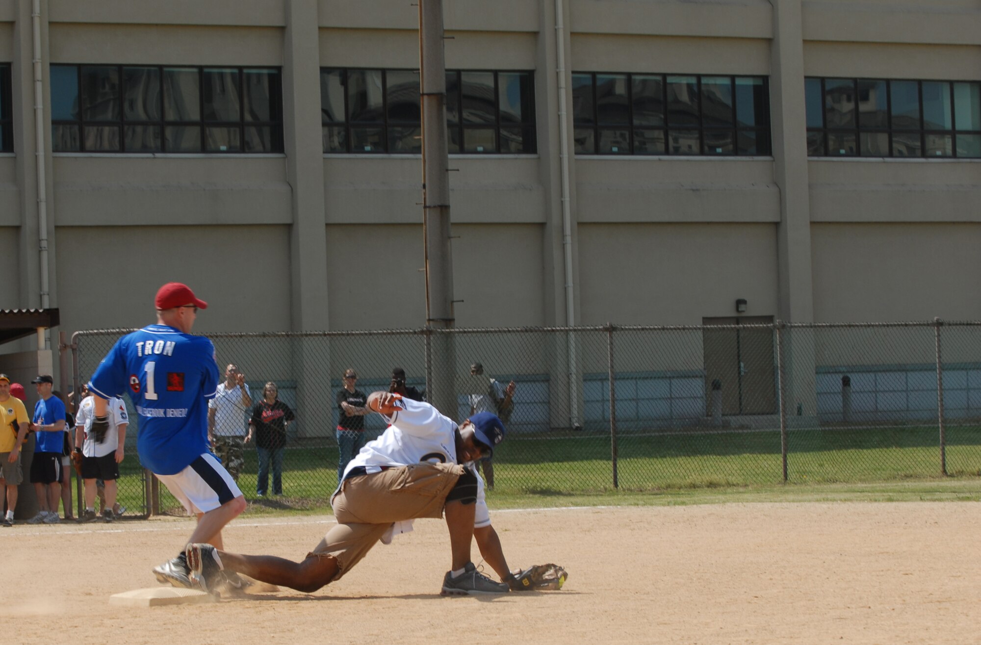Chief Master Sgt. Patrick Jones, 8th Civil Engineer Squadron, catches the ball a second too late as Maj. Brian Snyder, 8th Communications Squadron commander, makes it safe to second base pitching during the Chiefs vs. Eagles softball game May 4, 2012, on Kunsan Air Base, Republic of Korea. The chiefs beat the colonels 27-7. (U.S. Air Force photo/Senior Airman Brigitte N. Brantley)