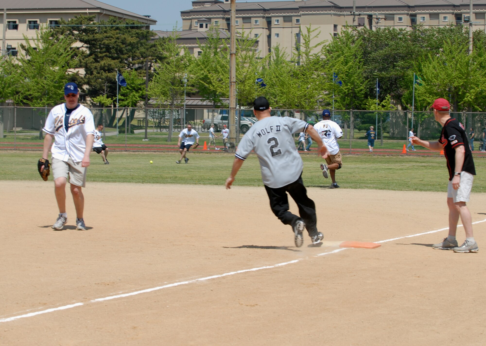 Col. Stephen Williams, center, 8th Fighter Wing vice commander, rounds first base during the Chiefs vs. Eagles softball game May 4, 2012, on Kunsan Air Base, Republic of Korea. Although the colonels started out strongly, the chiefs took the lead and won 27-7. (U.S. Air Force photo/Senior Airman Brigitte N. Brantley)