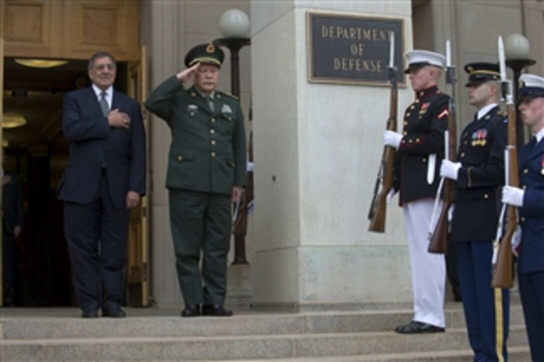 Secretary of Defense Leon E. Panetta and China’s Minister of National Defense Gen. Liang Guanglie salute during the playing of the National Anthem at a Pentagon arrival ceremony for Liang on May 7, 2012.  