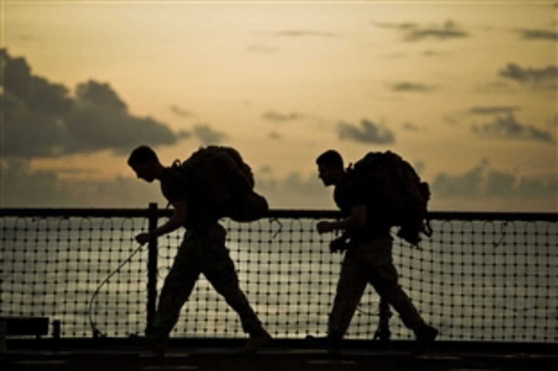 Navy Lt. James E. Lamb, left, and Sgt. Ryan Eskandary exercise aboard the USS Pearl Harbor, May 6, 2012. Lamb and Eskandary serve with the 11th Marine Expeditionary Unit’s command element. The unit embarked the USS Makin Island, USS New Orleans and USS Pearl Harbor in San Diego, Nov. 14, beginning a seven-month deployment to the Western Pacific, Horn of Africa and Middle East regions.