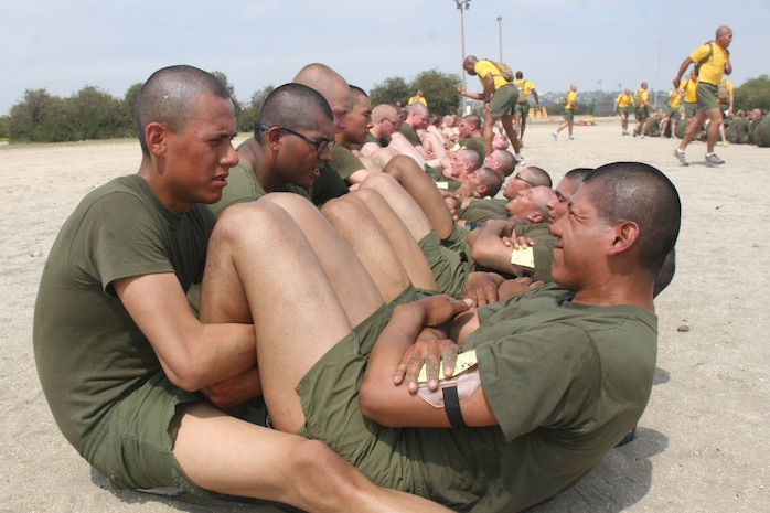 Recruits of Company E, 2nd Recruit Training Battalion, hold the legs of their fellow recruits and count the number of crunches each does during the inventory physical fitness test May 7 aboard Marine Corps Recruit Depot San Diego. The inventory PFT allows recruits to see where they stand in their physical performance before they run the final PFT the following week.