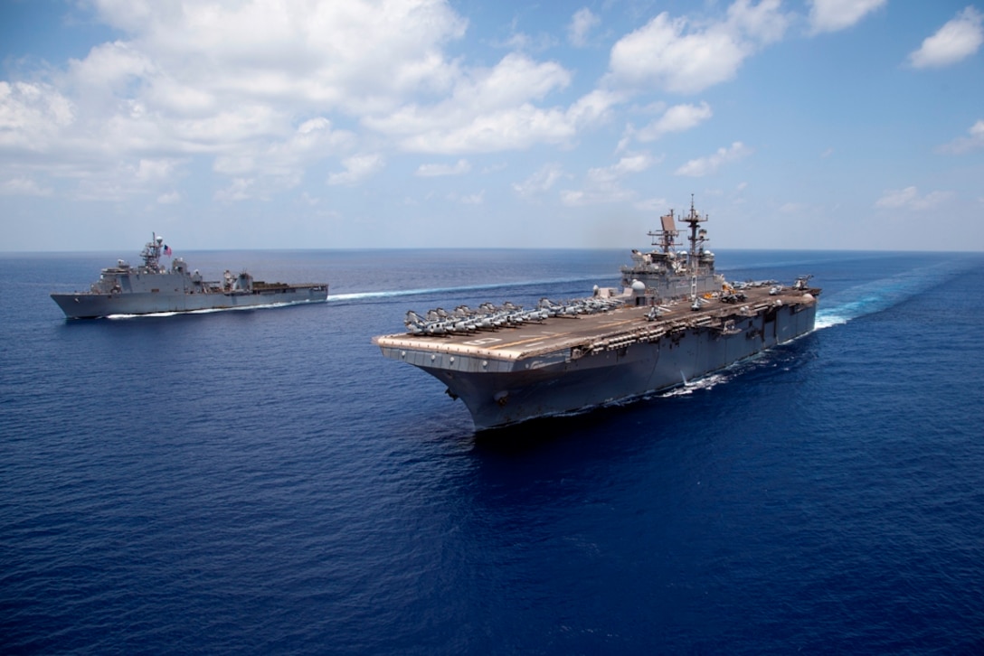 USS Pearl Harbor, left, and USS Makin Island, embarked with Marines and sailors serving with the 11th Marine Expeditionary Unit, sail here May 8. The unit embarked the ships, as well as USS New Orleans, in San Diego Nov. 14, beginning a seven-month deployment to the Western Pacific, Horn of Africa and Middle East regions.