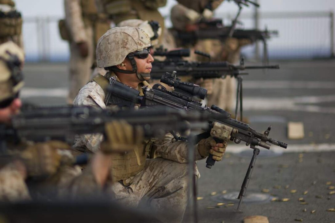Cpl. Calvin S. Ocon fires an M249 machine gun aboard USS Pearl Harbor May 8 during live-fire training. Ocon hails from Covina, Calif., and serves as a fire support man for the 11th Marine Expeditionary Unit. The unit embarked the ship, as well as USS Makin Island and USS New Orleans in San Diego Nov. 14, beginning a seven-month deployment to the Western Pacific, Horn of Africa and Middle East regions.