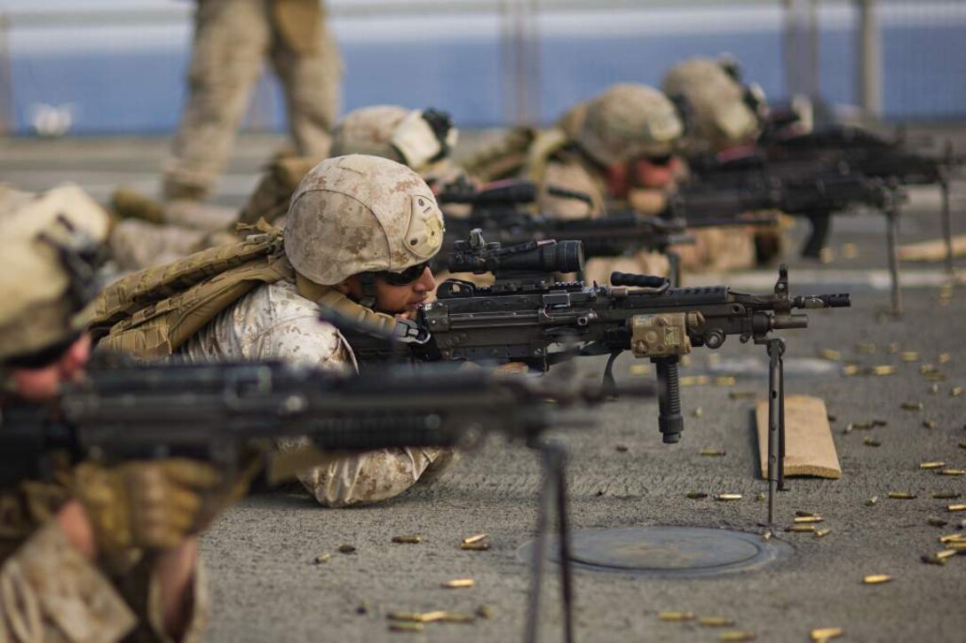 Cpl. Calvin S. Ocon fires an M249 machine gun aboard USS Pearl Harbor May 8 during live-fire training. Ocon hails from Covina, Calif., and serves as a fire support man for the 11th Marine Expeditionary Unit. The unit embarked the ship, as well as USS Makin Island and USS New Orleans in San Diego Nov. 14, beginning a seven-month deployment to the Western Pacific, Horn of Africa and Middle East regions.