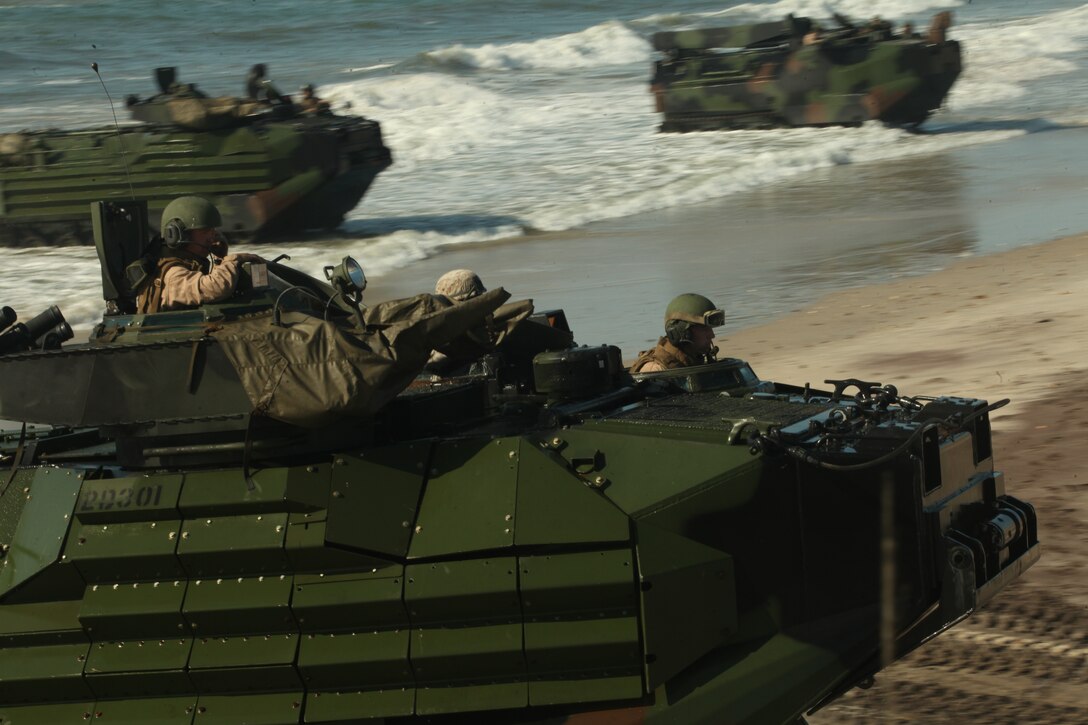 U.S. Marines Corps Assault Amphibious Vehicles from Security Cooperation Task Force Africa Partnership Station 12, make landfall during a mock non-combatant evacuation operation, May 9, 2012, on Onslow Beach, Camp Lejeune, N.C. This training was part of APS-12's certification in order to support stability operations during their upcoming deployment.::r::::n::::r::::n::::r::::n::::r::::n::::r::::n::