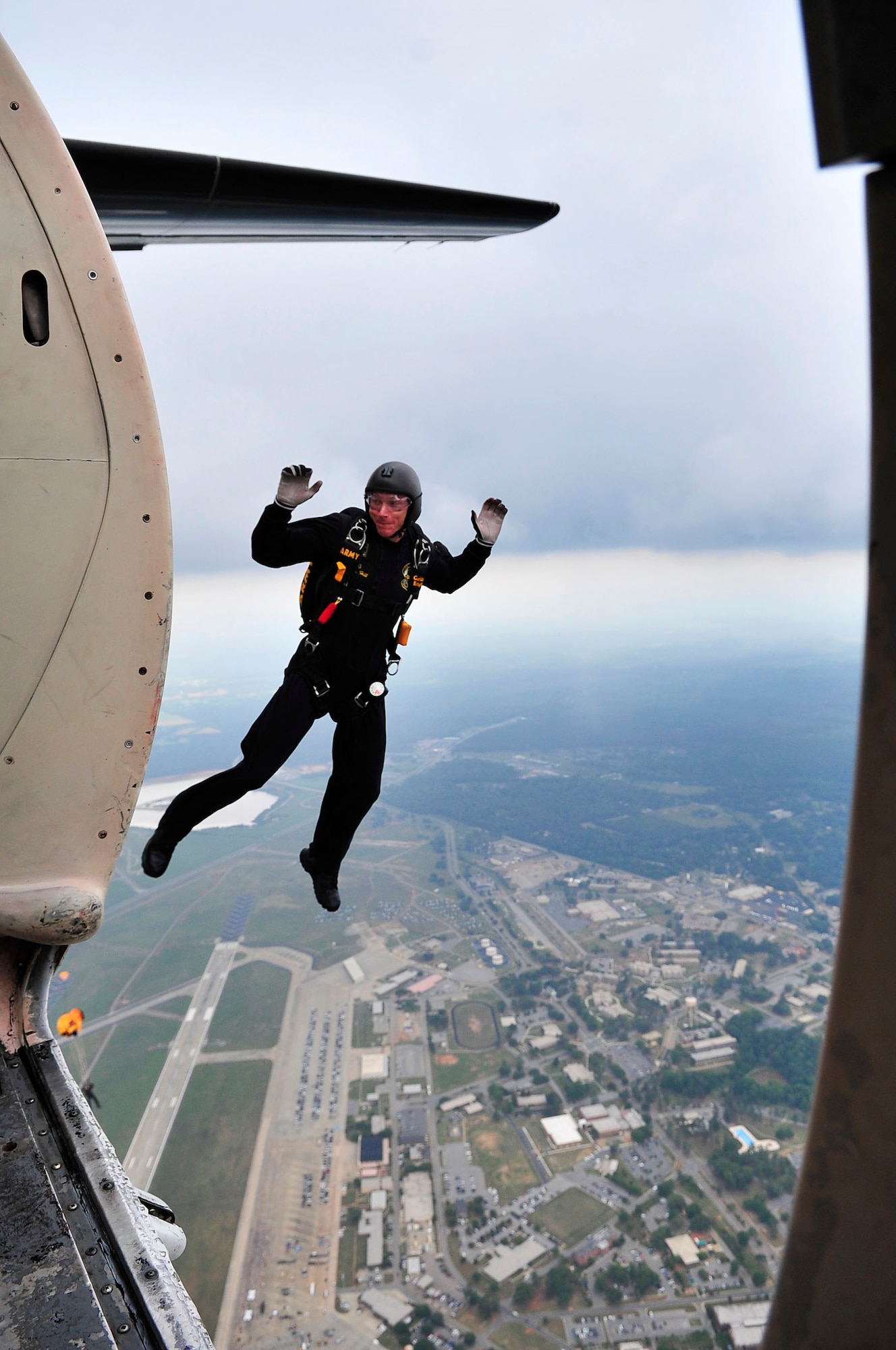 U.S. Army Sgt. 1st Class, U.S. Army Parachute Team "Gold Knights", performs a parachute jump demonstration at the Shaw Air Expo, Shaw Air Force Base, S.C., May 6, 2012.  The Golden Knights consists of two teams, the black team and the gold team, which travel across the U.S. performing at air shows and other competitions.(U.S. Air Force photo by Airman Nicole Sikorski/Released)