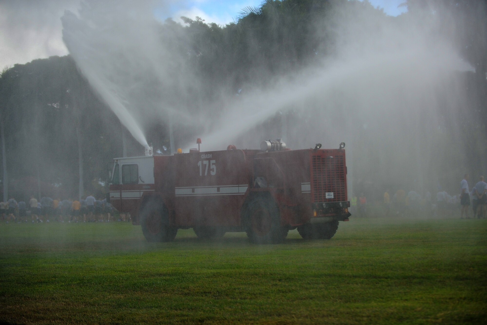 Airmen assigned to Federal Fire Department, Joint Base Pearl Harbor-Hickam, Hawaii, sprays the crowd after they were dismissed from formation at the conclusion of the two-mile Team Hickam Warrior Run May 3.  This event was sponsored by the 647th Civil Engineers Squadron and their Prime BEEF Airmen. Prime BEEF, is a Prime Base Engineer Emergency Force is a rapidly deployable, specialized civil engineer unit of the Air Force Prime BEEFs provide a full range of engineering support required to establish, operate, and maintain garrison and contingency airbases. The Prime BEEF motto is "If you mess with the bull, you get the horns." (U.S. Air Force photo/Staff Sgt. Mike Meares)