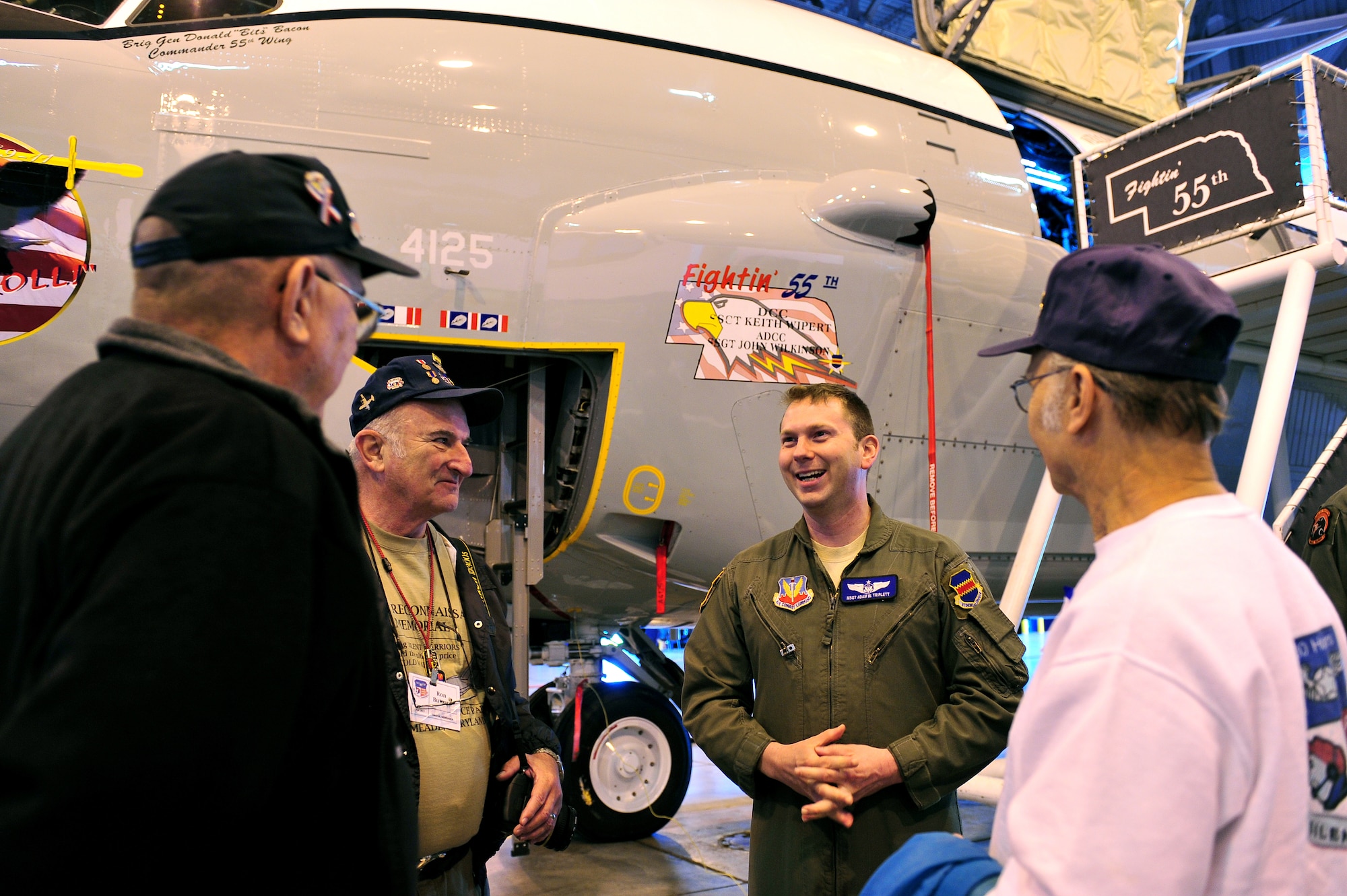 U.S. Air Force Master Sgt. Adam Triplett, 97th Intelligence Squadron, speaks with some members of the Prop Wash Gang during the Doggers and Prop Wash Gang visit at the Bennie Davis Maintenance Facility Dock 1 on Offutt Air Force Base, Neb., April. 27. The two groups met and celebrated on the weekend before the 37th anniversary of the fall of Saigon. (U.S. Air Force photo by Charles Haymond/Released)