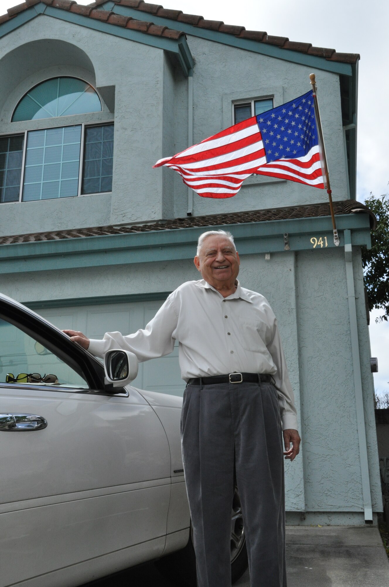 Master Sgt. (Ret.) Sam Katchmar stands beside his American dream car
and new California home. (U.S. Air Force photo/Staff Sgt. Timothy Boyer)
