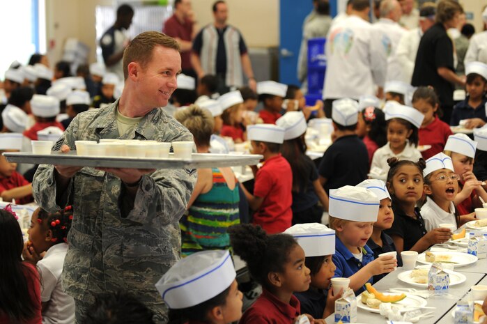 U.S. Air Force Staff Sgt. Brennan Smith, 820th RED HORSE power production craftsman, serves fruit smoothies at a Chefs for Kids event May 3, 2012, at Rex Bell Elementary School in Las Vegas, Nev. Smith has been volunteering with Chefs for Kids every month for over a year. (U.S. Air Force photo by Staff Sgt. William P.Coleman)  