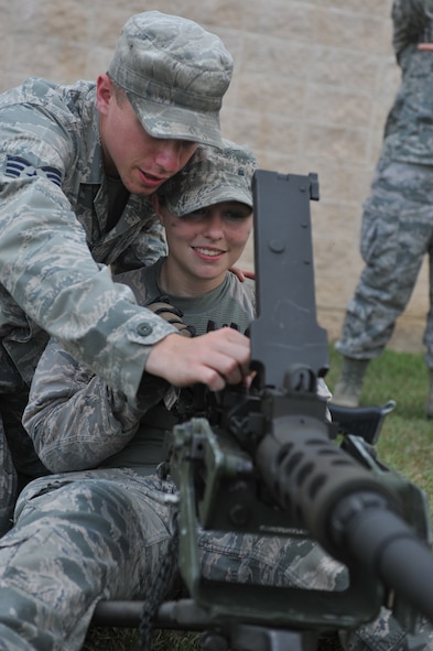 U.S. Air Force Senior Airman Nicholas Sellers shows his wife, Jade, how to operate the M2 machine gun during the 822nd Base Defense Squadron spouse immersion day at Moody Air Force Base, Ga., May 4, 2012. Military Spouse Appreciation Day has been observed since 1984. (U.S. Air Force photo by Airman 1st Class Jarrod Grammel/Released)
