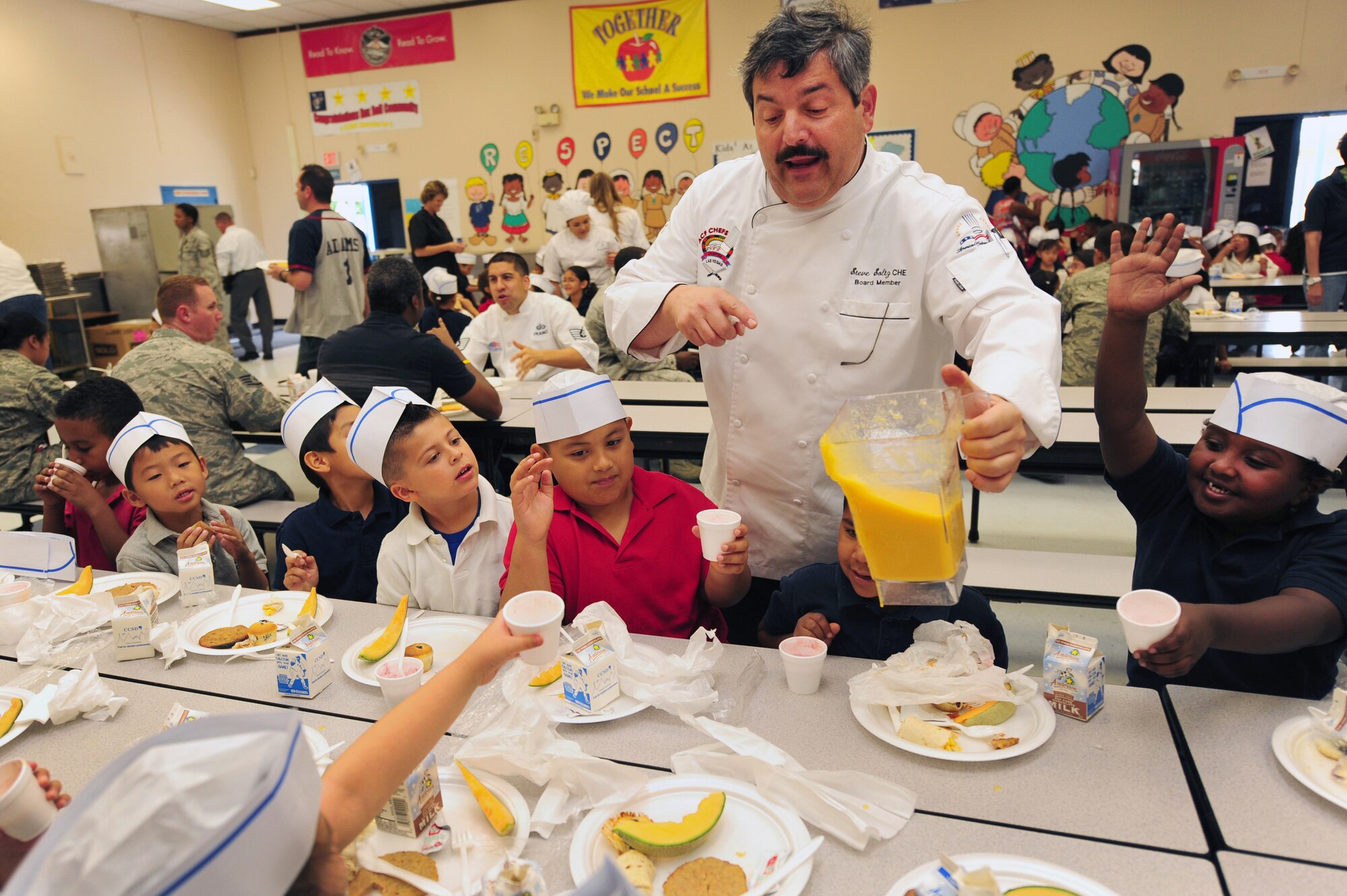 Chef Steve Soltz, College of Southern Nevada culinary arts professor, refills fruit smoothies at a Chefs for Kids event May 3, 2012, at Rex Bell Elementary School in Las Vegas, Nev. Soltz is a board member of the American Culinary Federation and was named their 2010  Chef of the Year for Las Vegas. (U.S. Air Force photo by Staff Sgt. William P.Coleman)
  

