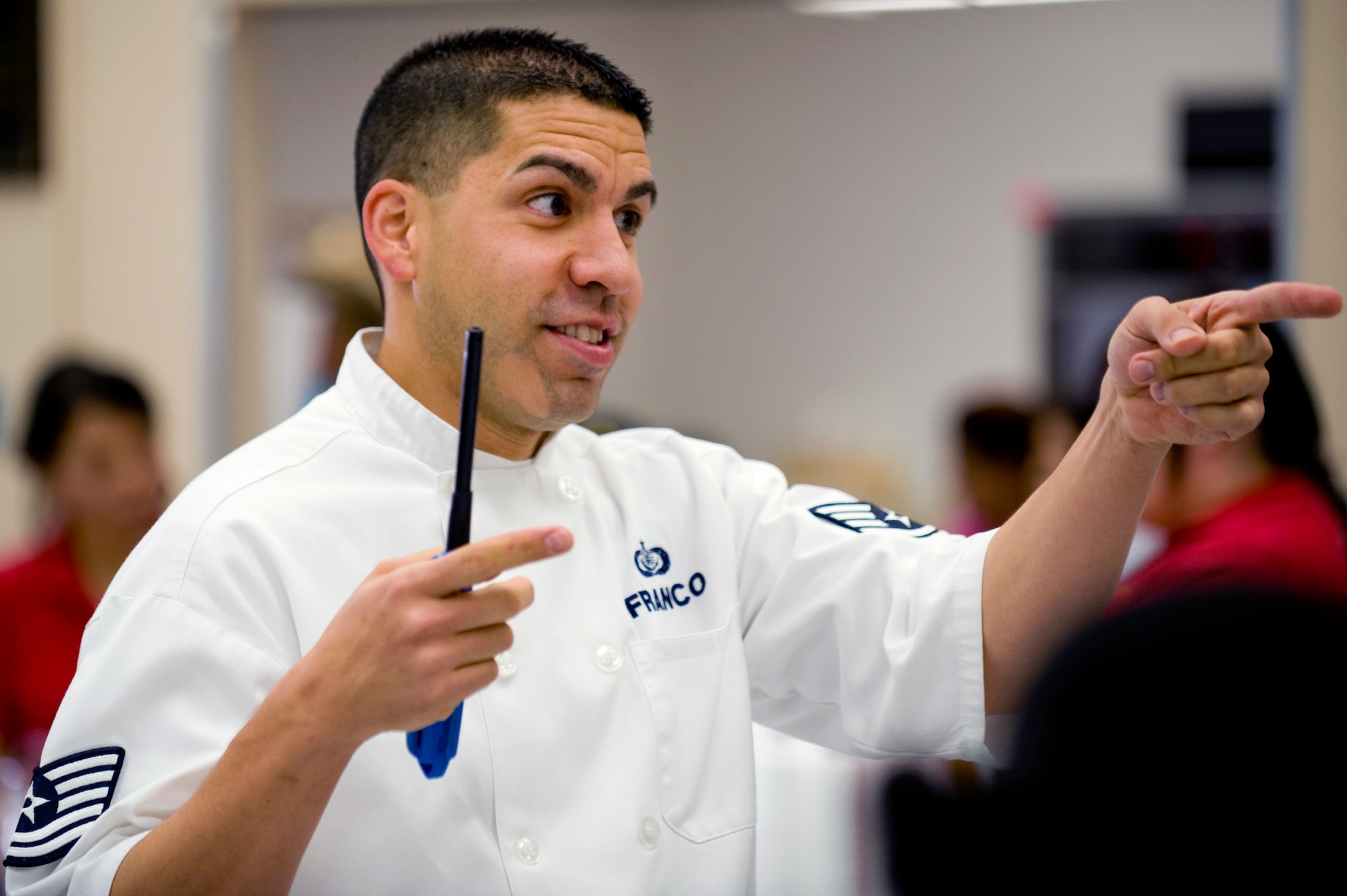 U.S. Air Force Tech Sgt. Justin Franco, 99th Force Support Squadron services craftsman, directs other Airman volunteers at a Chefs for Kids event, May 3, 2012, at Rex Bell Elementary School in Las Vegas, Nev. Franco, along with seven Airman from Nellis Air Force Base, Nev., helped serve 884 students breakfast. (U.S. Air Force photo by Staff Sgt. William P.Coleman)
  

