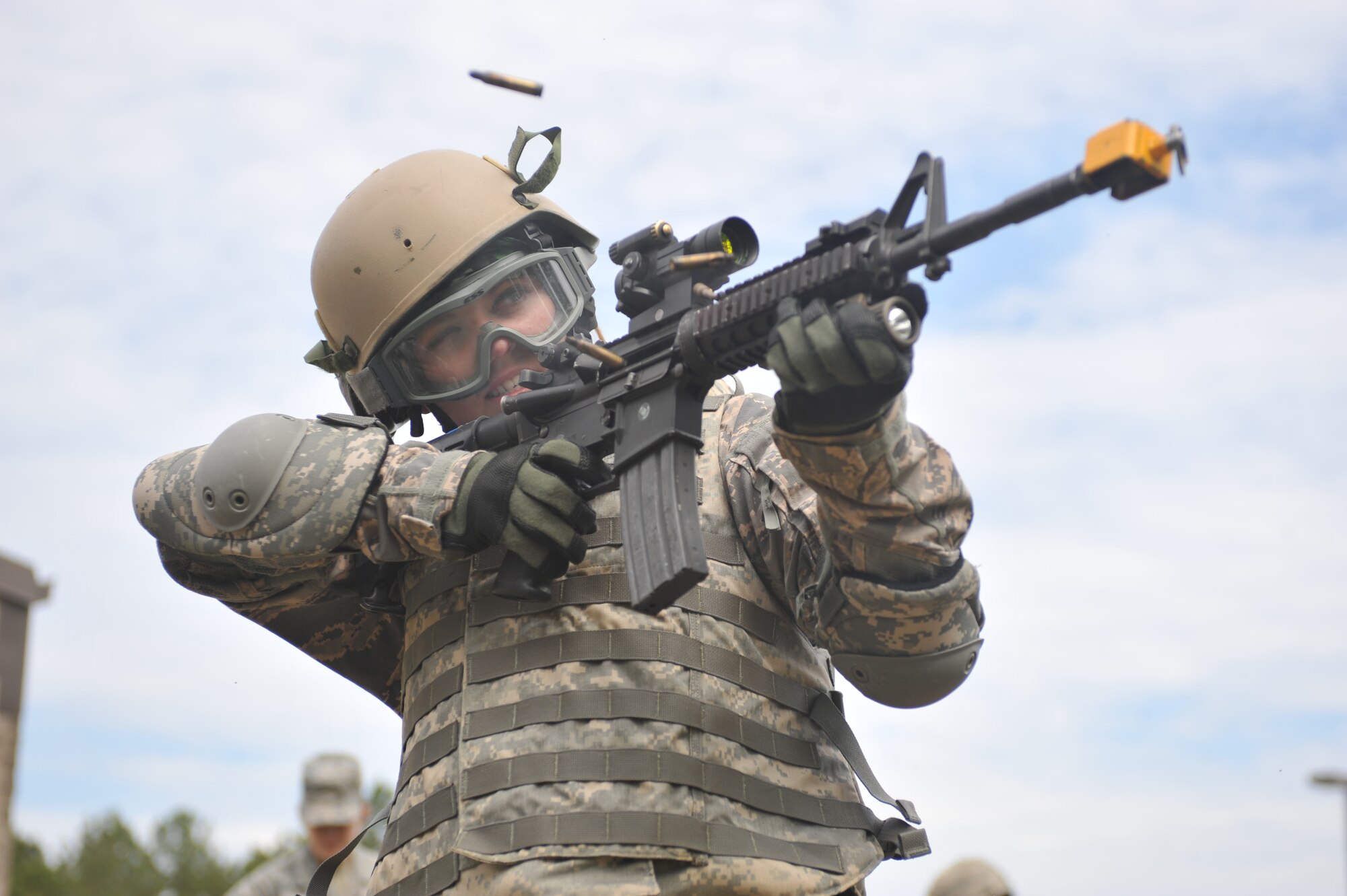 Christina Kurtz, spouse of U.S. Air Force Staff Sgt. Bradley Kurtz, fires a burst of blank rounds from an M4 carbine during the 822nd Base Defense Squadron spouse immersion day at Moody Air Force Base, Ga., May 4, 2012. The spouses learned weapons safety, operating procedures and fired blank rounds. (U.S. Air Force photo by Airman 1st Class Jarrod Grammel/Released)
