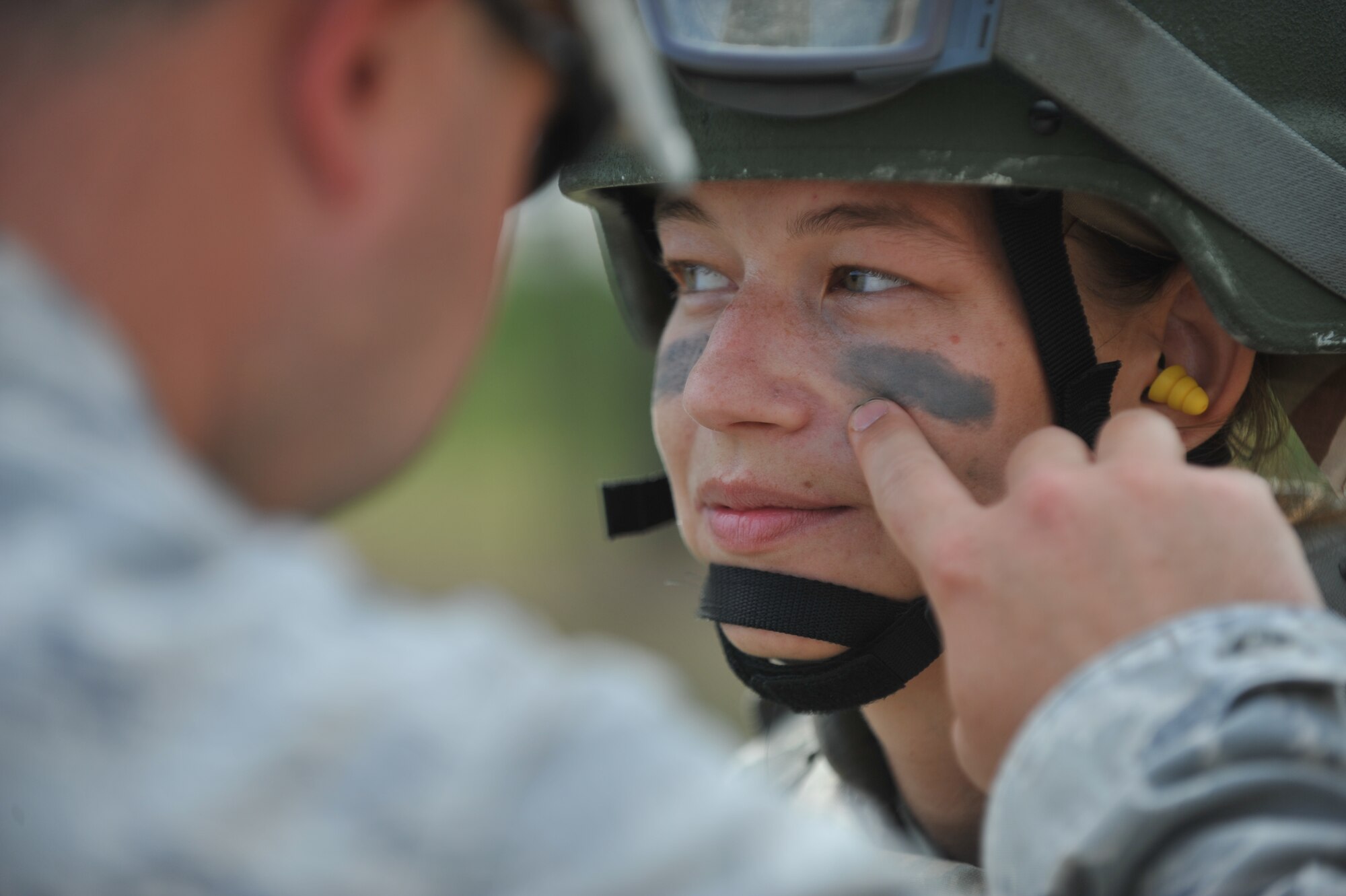 Jaqie Johnson, spouse of U.S. Air Force Staff Sgt. Greg Johnson, gets her face painted during the 822nd Base Defense Squadron spouse immersion day at Moody Air Force Base, Ga., May 4, 2012. For the majority of the day, the spouses had to wear full gear including body armor and a helmet. (U.S. Air Force photo by Airman 1st Class Jarrod Grammel/Released)
