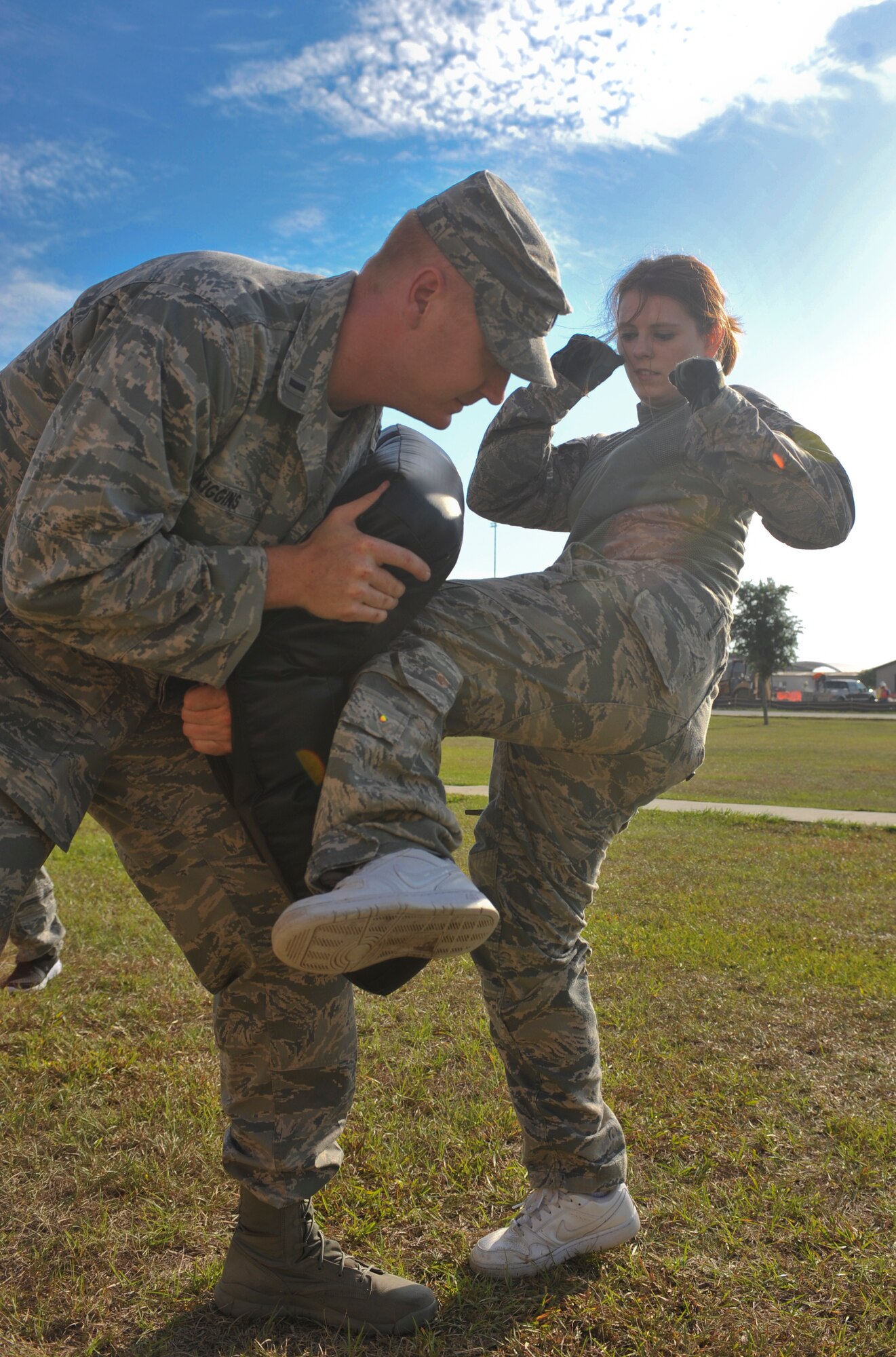 Christina Kurtz, spouse of U.S. Air Force Staff Sgt. Bradley Kurtz, knees a combatives pad during the 822nd Base Defense Squadron spouse immersion day at Moody Air Force Base, Ga., May 4, 2012. The spouse immersion day was held as part of Military Spouse Appreciation Day.  (U.S. Air Force photo by Airman 1st Class Jarrod Grammel/Released)
