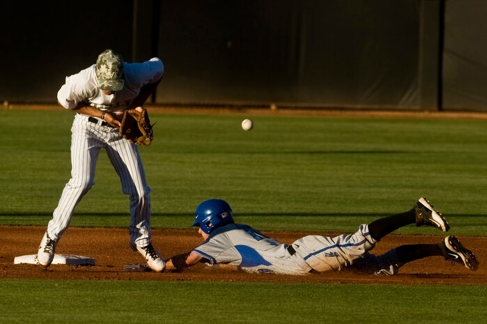 A U.S. Air Force Academy Falcons player slides under a missed catch during a game against the University of Nevada, Las Vegas Rebels April 20, 2012, at Earl E. Wilson Stadium in Las Vegas, Nev. The Falcons baseball team got swept during the three game series in Las Vegas. (U.S. Air Force photo by Airman 1st Class Daniel Hughes)