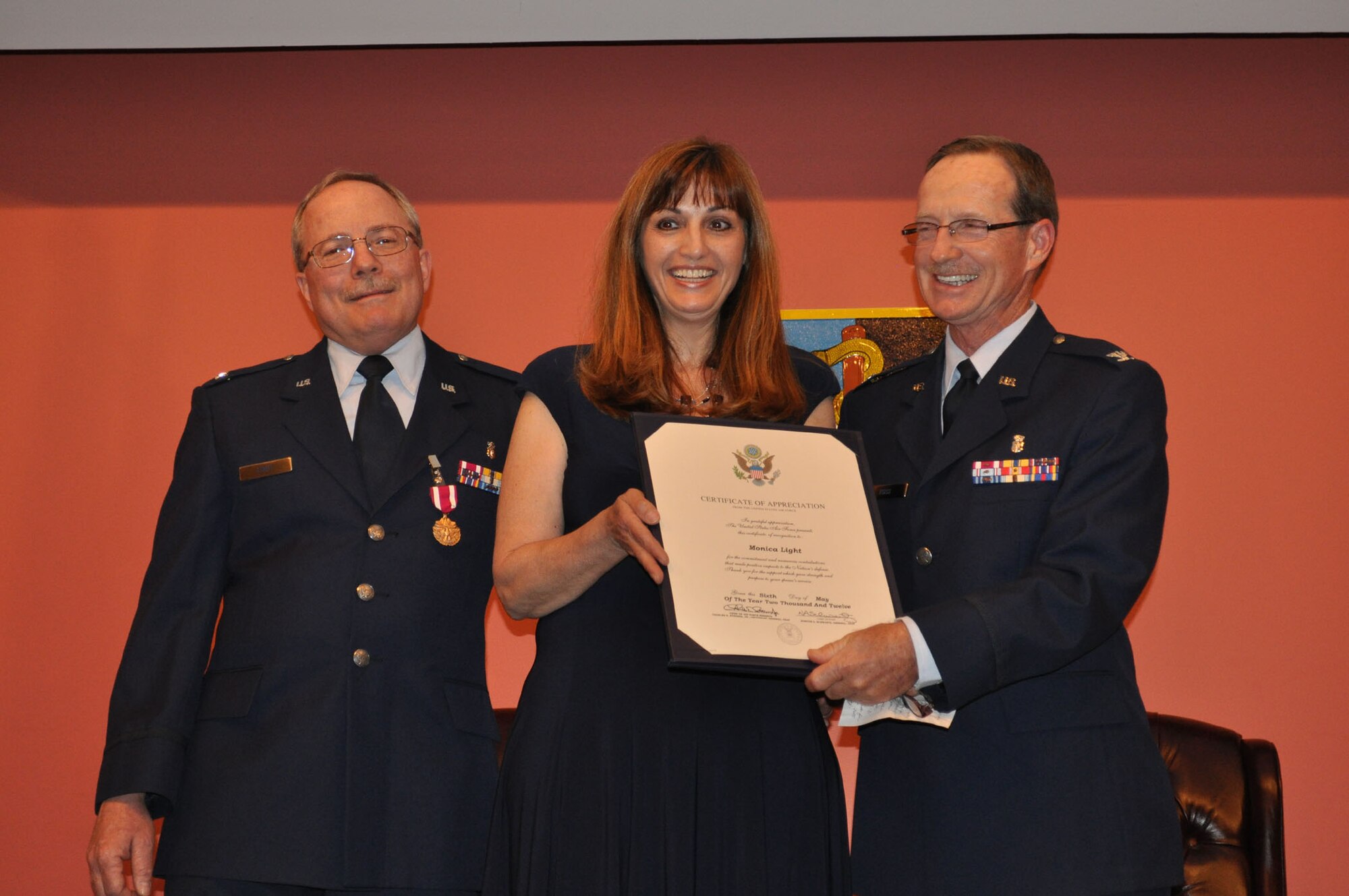 TRAVIS AIR FORCE BASE, Calif. -- Col. Jeffrey Light, 349th Aerospace Medical Squadron office in charge of self-inspection, is joined by friends, family and coworkers, during his retirement ceremony at Travis Air Force Base, Calif., on May 6, 2012. Colonel Light is retiring after 27 years as a Reservist at Travis. (U.S. Air Force photo/Tech. Sgt. Rachel Martinez)
