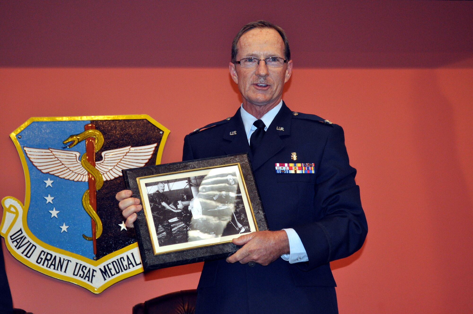 TRAVIS AIR FORCE BASE, Calif. -- Col. Jeffrey Light, 349th Aerospace Medical Squadron office in charge of self-inspection, is joined by friends, family and coworkers, during his retirement ceremony at Travis Air Force Base, Calif., on May 6, 2012. Colonel Light is retiring after 27 years as a Reservist at Travis. (U.S. Air Force photo/Tech. Sgt. Rachel Martinez)