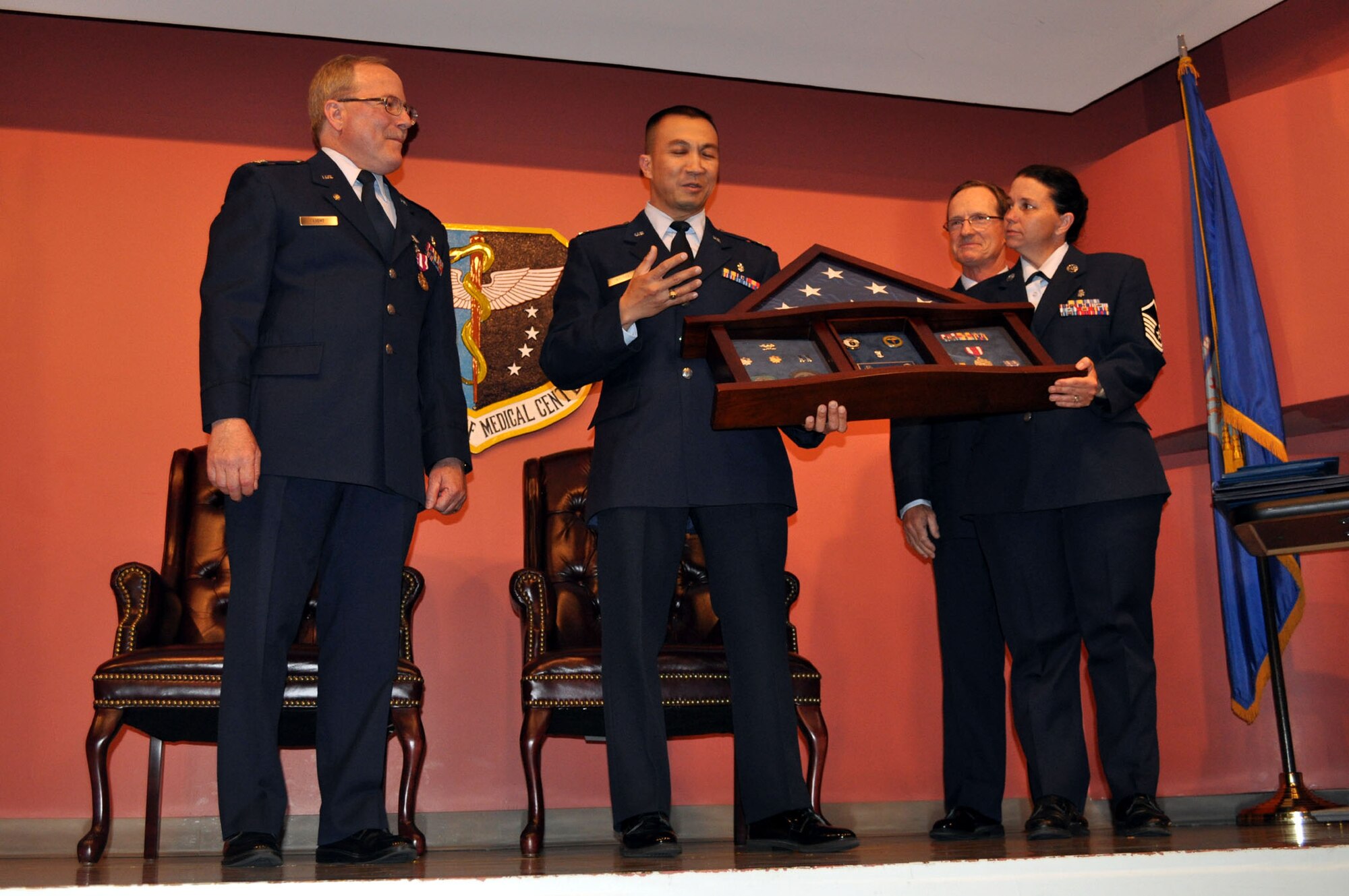 TRAVIS AIR FORCE BASE, Calif. -- Col. Jeffrey Light, 349th Aerospace Medical Squadron office in charge of self-inspection, is joined by friends, family and coworkers, during his retirement ceremony at Travis Air Force Base, Calif., on May 6, 2012. Colonel Light is retiring after 27 years as a Reservist at Travis. (U.S. Air Force photo/Tech. Sgt. Rachel Martinez)