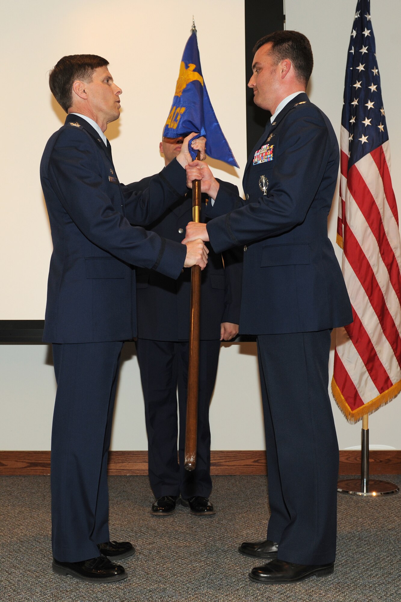 Lt. Col. Richard D. Henderson, right, the new commander of the 222nd Command and Control Squadron, receives the squadron guidon from Col. Greg Semmel, commander of the 174th Fighter Wing, during a ceremony Friday at the Rome Air Force Research Laboratory.