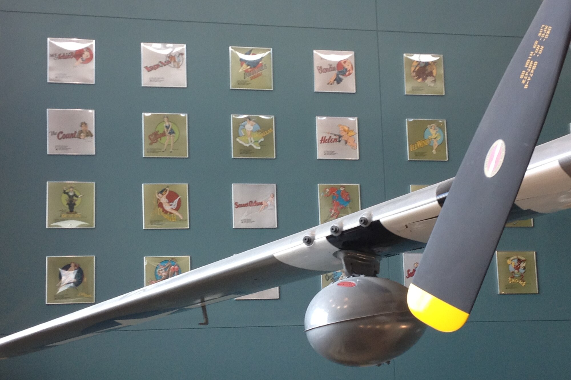 Nose art painted by World War II veteran, Staff Sgt. Don Allen, is displayed in the atrium of the Seymour Johnson Consolidated Support Center next to a P-51 Mustang, May 8, 2012. Allen will visit the support center May 18 at 1 p.m., to meet with Airmen and see how operations have changed 70 years later. (U.S. Air Force photo/Senior Airman Rae Perry/Released)