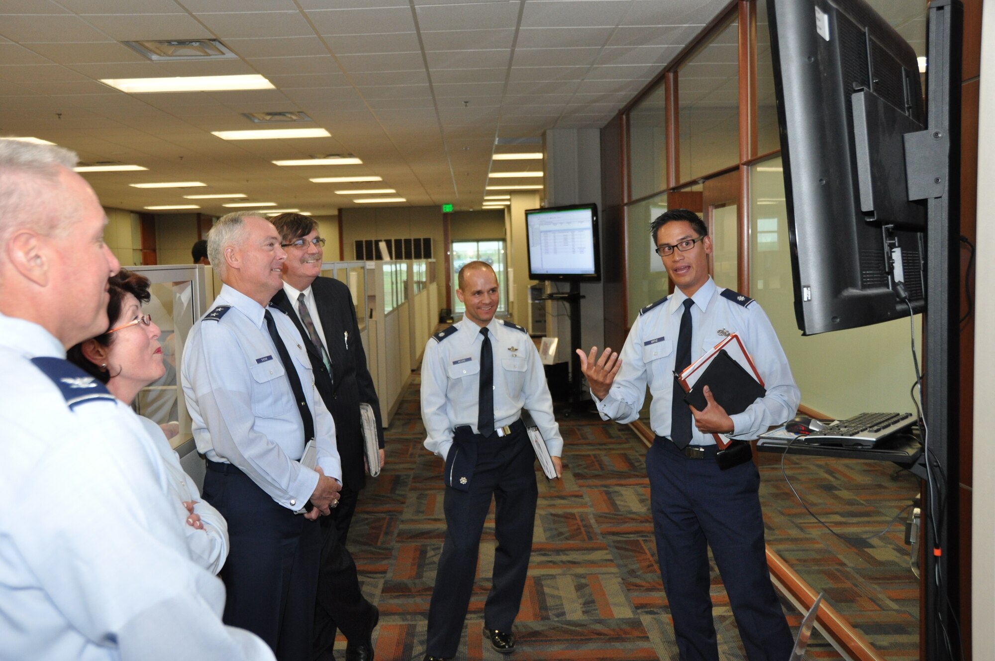 Maj. Gen. Richard Shook, Jr., Mobilization Assistant to the Chief, Air Force Reserve is briefed on Total Force Service Center - Denver operations by Lt. Col. Michael Ortiz, Air Reserve Personnel Center contact center operations chief, during his visit May 8, 2012, on Buckley Air Force Base, Colo. General Shook visited with ARPC employees, received a mission briefing and discussed key topics with Colonel Patricia Blassie, ARPC commander, and other senior leadership at the Center. (U.S. Air Force photo/Tech. Sgt. Rob Hazelett)