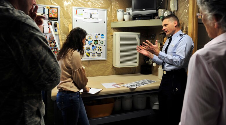 Artist Claudia Gullet and Col. Michael Hornitschek, 375th Air Mobility Wing commander, discuss the placement of ceramic tiles in the mural she's creating for the Student Union, sheduled to open in June.  (U.S. Air Force photo/ Staff Sgt. Stephenie Wade)