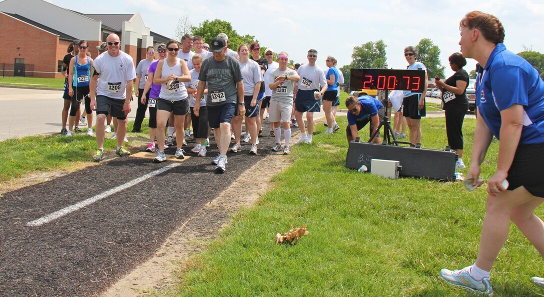 Runners check their watches before the start of the second annual 5K/10K Fun Run sponsored by the 932nd AW First Sergeants.  Trophies were presented to the fastest male and female runners.  The event helps the First Sergeants raise funds for unit morale and welfare activities.  (U.S. Air Force photo/Tech. Sgt. Dan Oliver)