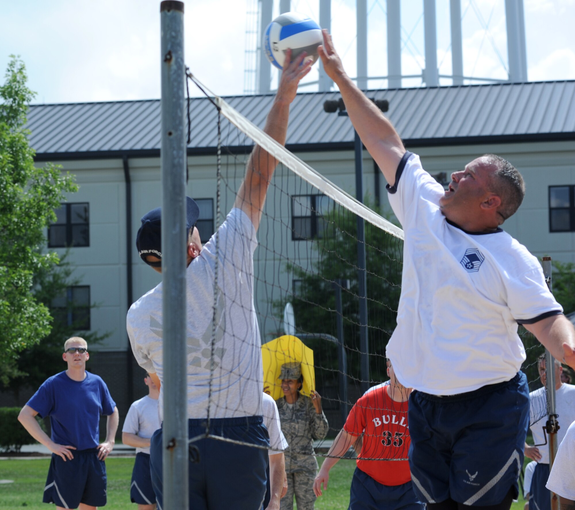 Brig. Gen. Andrew Mueller, 81st Training Wing commander, leaps to defend as Chief Master Sgt. Tracy Putt, 81st Dental Squadron, tips the ball over the net at a volleyball match between the commanders and the chiefs during Sports Day May 4, 2012, at Keesler Air Force Base, Miss.  The chiefs defeated the commanders.  Sports Day was held in conjunction with May’s National Physical Fitness and Sports Month.   The event consisted of a variety of sports with participation from the many squadrons on base.  The winner of the small squadron division was 81st Training Support Squadron and the winner of the large squadron division was the 334th Training Squadron.  (U.S. Air Force photo by Kemberly Groue)