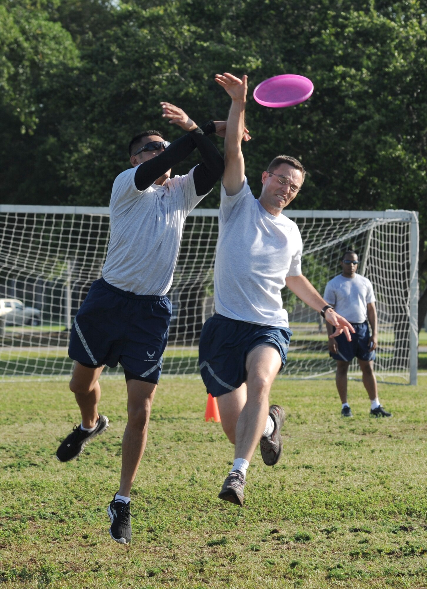 Senior Airman Martell Benitez, Wing Staff Agency team, leaps for the Frisbee catch as 2nd Lt. Richard Sackett, 333rd Training Squadron, makes the block during an Ultimate Frisbee tournament for Sports Day May 4, 2012, at Keesler Air Force Base, Miss.  The 333rd defeated the WSA team, 6-1.  Sports Day was held in conjunction with May’s National Physical Fitness and Sports Month.   The event consisted of a variety of sports with participation from the many squadrons on base.  The winner of the small squadron division was 81st Training Support Squadron and the winner of the large squadron division was the 334th Training Squadron.  (U.S. Air Force photo by Kemberly Groue)