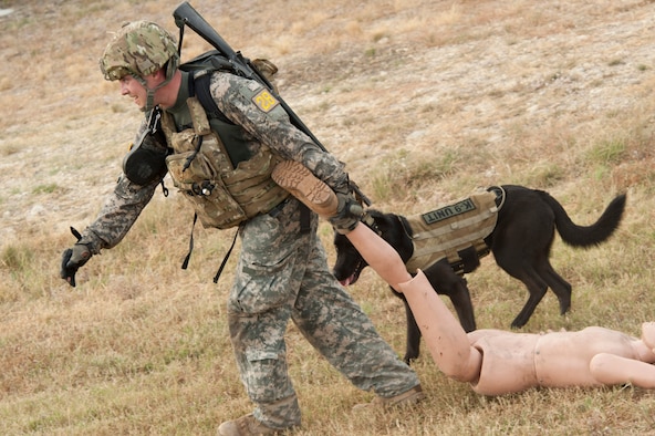 U.S. Army Sgt. David Varkett drags a 200-pound dummy during the Department of Defense Military Working Dog Trials at Joint Base San Antonio-Lackland, Texas, May 4, 2012. Dog handlers and their canine counterparts completed several obstacles and scenarios during the trials that simulated possible real world situations. Varkett is a military working dog handler assigned to the 51st Military Police Detachment at Joint Base Lewis-McChord, Wash. (U.S. Air Force photo/Senior Airman Corey Hook/Released)