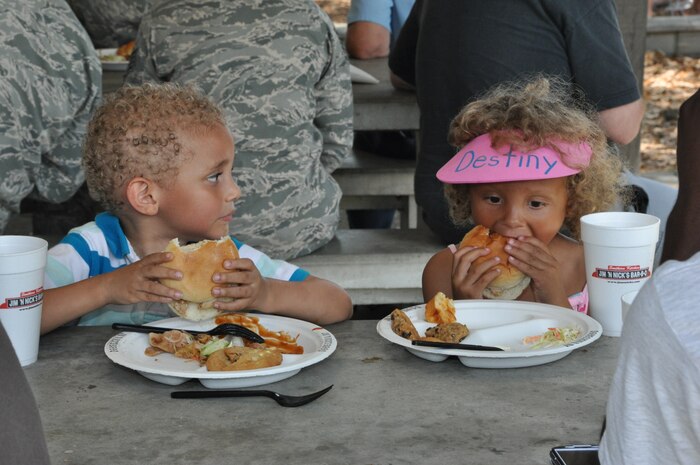 "How's lunch?" Two junior 315th Airlift Wing family members enjoy their sandwiches at the Joint Base Charleston Annual Picnic, May 5. (U.S. Air Force photo/Tech. Sgt. Scott Mathews)