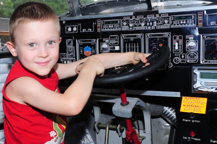 Josiah Bradbury "flies" the 315th Airlift Wing mini C-17 during the Joint Base Charleston Annual Picnic, May 4. The picnic was held to show appreciation for Team Charleston members. Josiah's mother is Staff Sgt. Stacey Bradbury, 628th Security Forces Squadron.  (U.S. Air Force photo/Airman 1st Class Chacarra Walker)