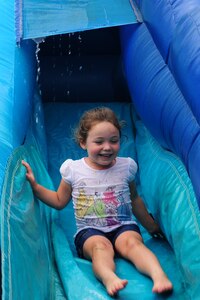 Grace Johnson slides down a water slide at the Joint Base Charleston Annual Picnic, May 4. The picnic was held to show appreciation for Team Charleston members. Grace's father is Staff Sgt. Sean Johnson, 628th Civil Engineer Squadron. (U.S. Air Force photo/Airman 1st Class Chacarra Walker)