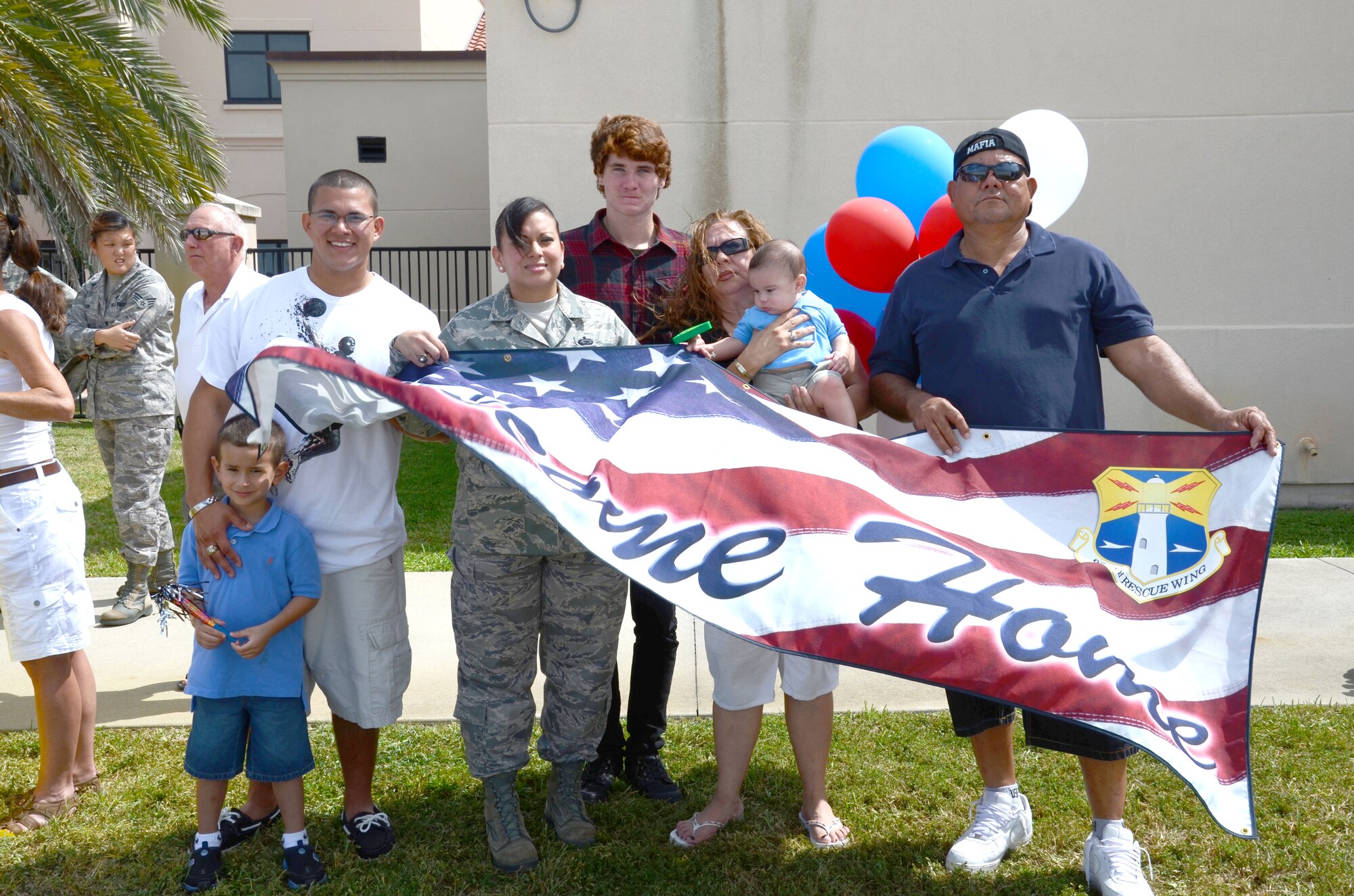 After a four month deployment, Tech. Sgt. Nikki Carden, chief, force management, 920th Rescue Wing, force support squadron, Patrick Air Force Base, Fla., and family anxiously await the arrival of her husband, Senior Master Sgt. David Carden, air ground equipment flight chief. One of the unit's peacetime missions are providing civil search and rescue support for those who are lost or in distress, and providing humanitarian and disaster-relief operations. (U.S. Air Force photo/Senior Airman Natasha Dowridge)