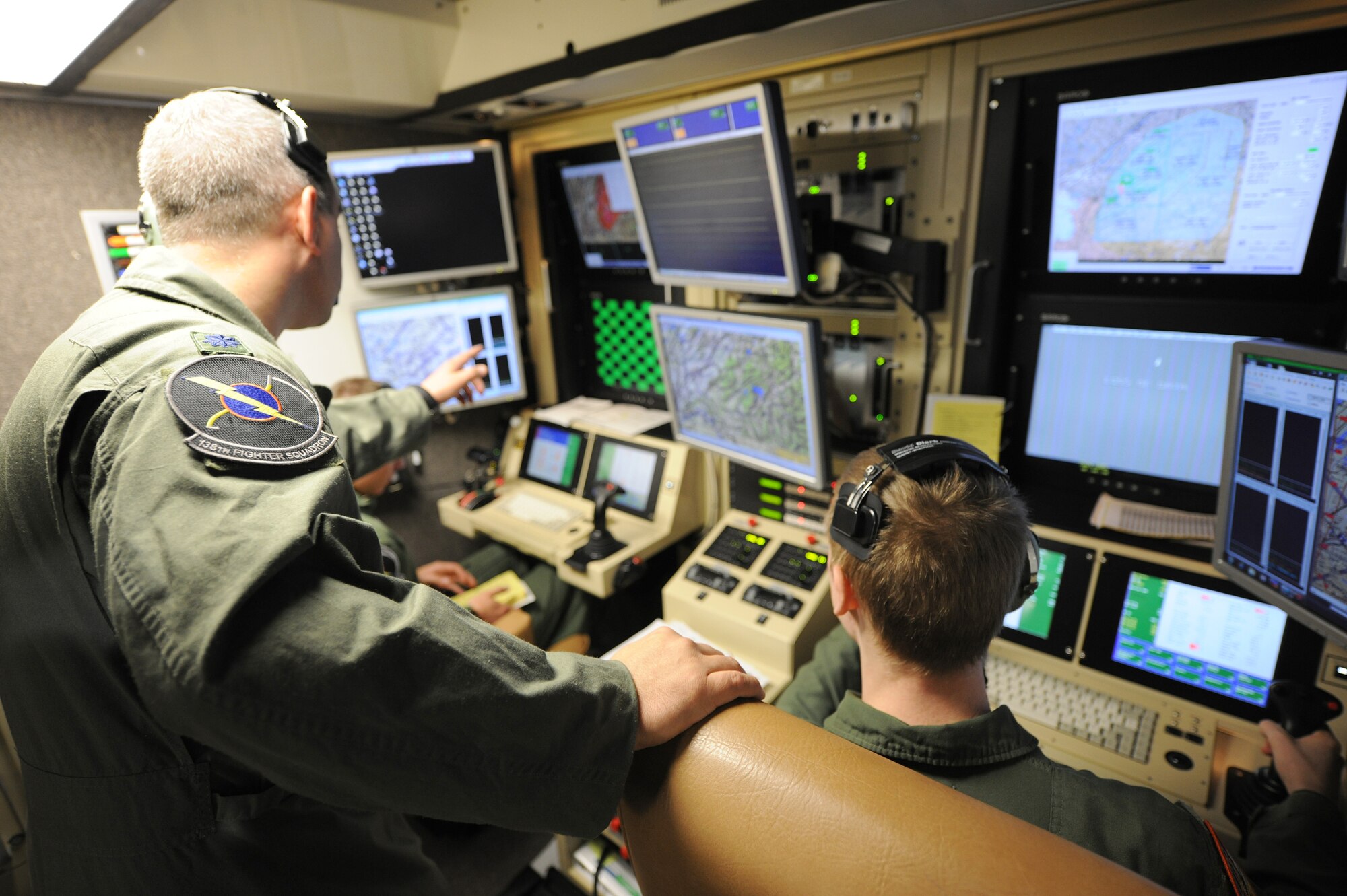 An instructor pilot makes a point during a MQ-9 Reaper training mission flown from a ground-based cockpit located at Hancock Field Air National Guard Base, Syracuse, New York.  The 174th Fighter Wing is the only Air National Guard unit in the country to operate a MQ-9 Formal Training Unit (FTU) program to train aircrews from the active duty Air Force, Air National Guard and Air Force Reserve.(photo by Tech. Sgt. Ricky Best/Released)
