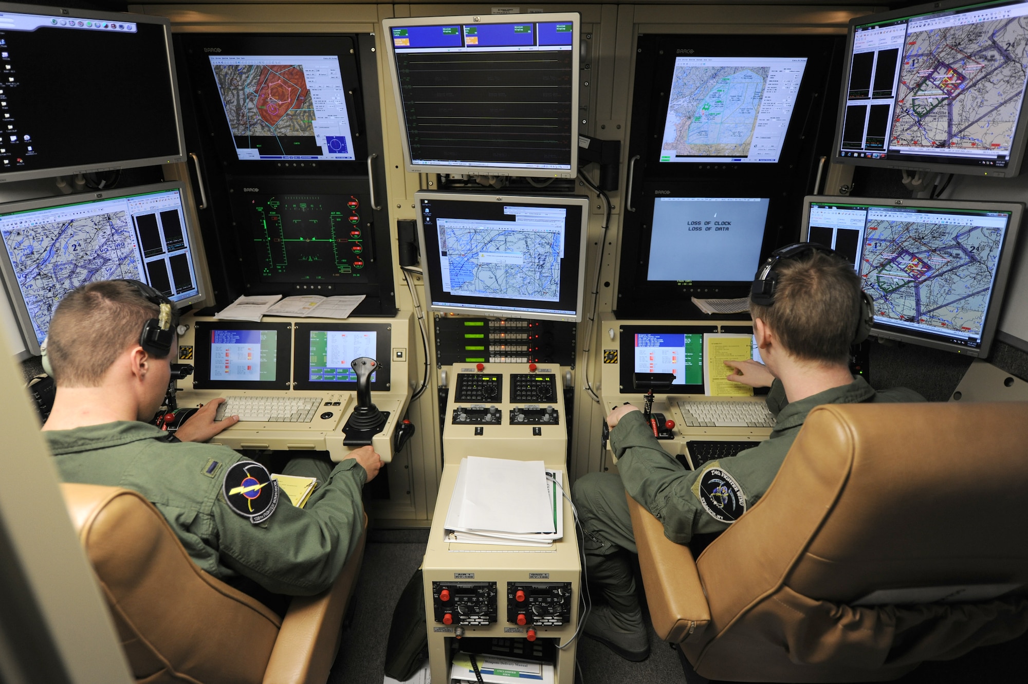 An active duty Air Force student pilot and sensor operator man the controls of a MQ-9 Reaper in a ground-based cockpit during a training mission flown from Hancock Field Air National Guard Base, Syracuse, New York.  The 174th Fighter Wing operates the only ANG MQ-9 Formal Training Unit (FTU) which trains aircrews from the active duty Air Force, Air National Guard and Air Force Reserve. (Photo by Tech. Sgt. Ricky Best/Released)
