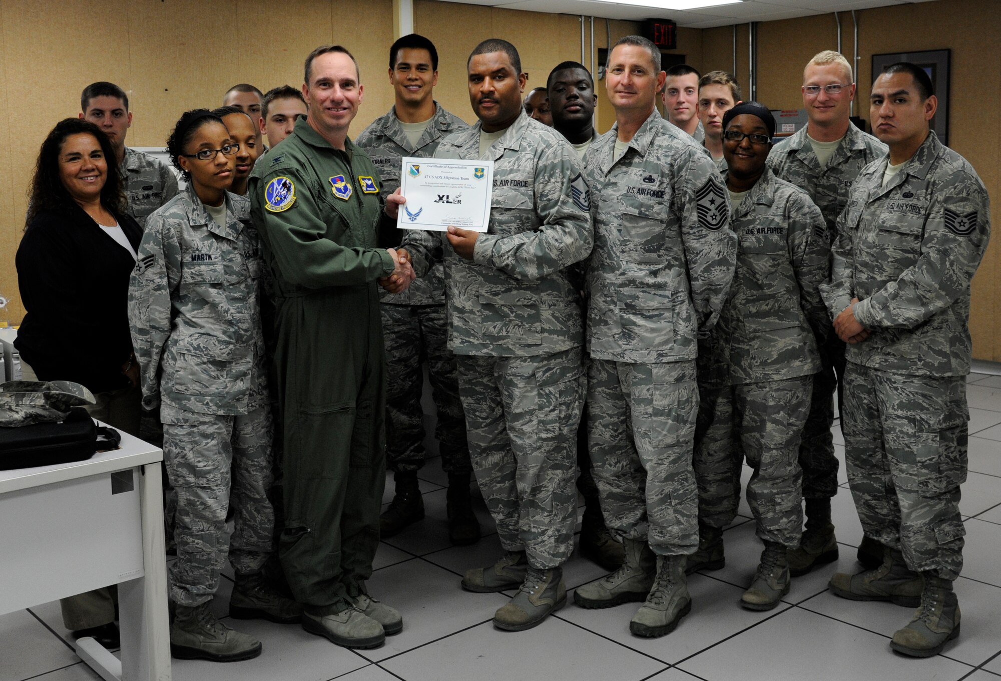 Members of Laughlin Air Force Base’s 47th Communications Squadron Active Directory and Exchange Migration Team pose with Col. Tom Murphy, 47th Flying Training Wing commander, and Chief Master Sgt. Ray DeVite, 47th FTW command chief, after being presented the XLer of the week award here May 2, 2012. The XLer is a weekly award chosen by wing leadership and given to those who consistently make outstanding contributions to Laughlin and their unit. (U.S. Air Force photo/Airman 1st Class Nathan Maysonet)