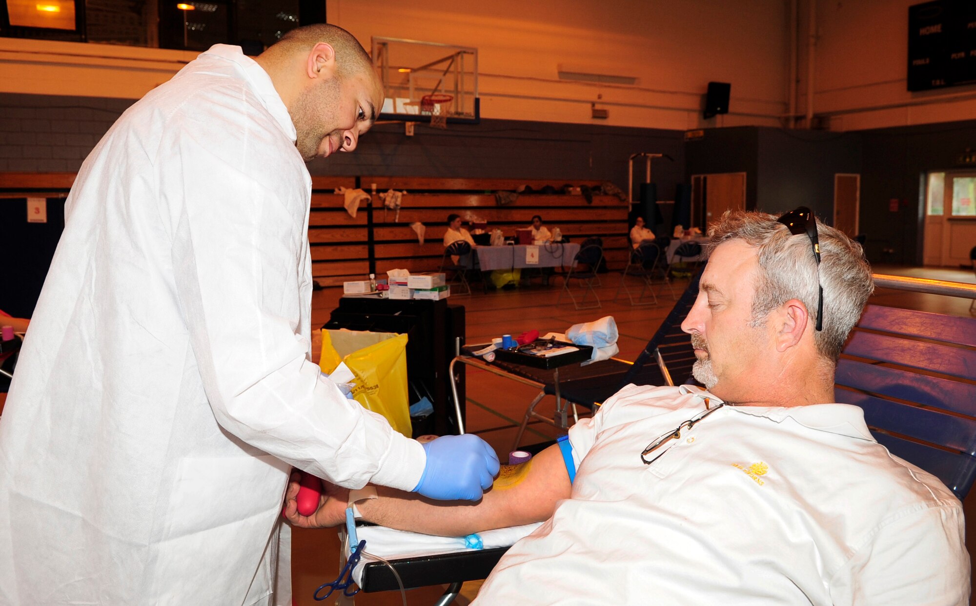 RAF MILDENHALL, England – Sam Castro, Armed Services Blood Program medical lab technician, uses iodine to sterilize the arm of Kevin Hawks, a retired senior master sergeant, at the blood drive here May 8, 2012. Many people took time out of their busy schedules to donate blood. Many said they intend to do it again when ASBP returns in the fall of 2012. (U.S. Air Force photo/Senior Airman Ethan Morgan)